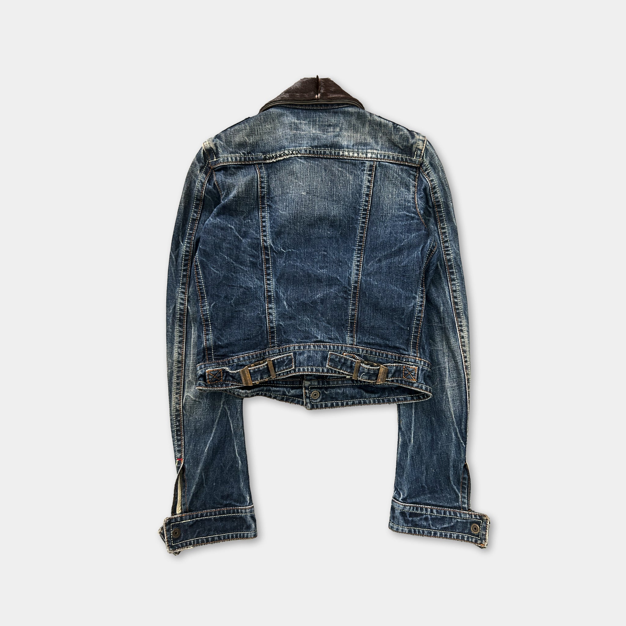 A denim jacket with a leather collar is shown against a white background.