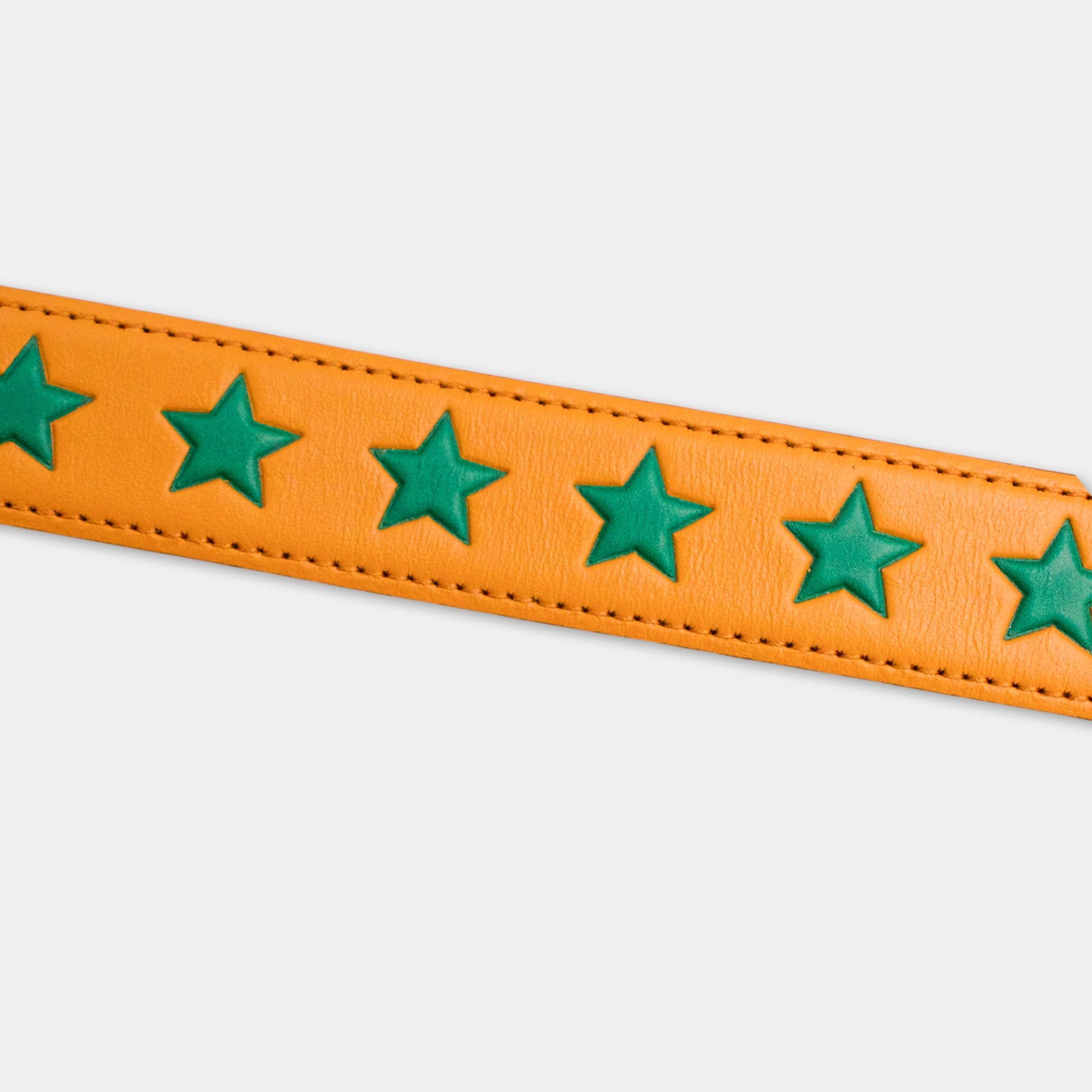a bright orange leather strap with green star-shaped embellishments.