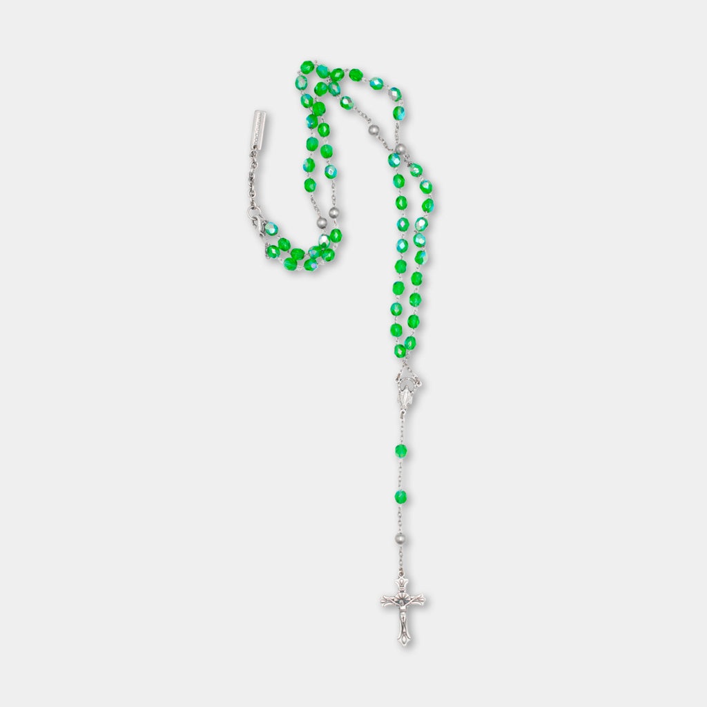 A necklace with green beads and a cross pendant.