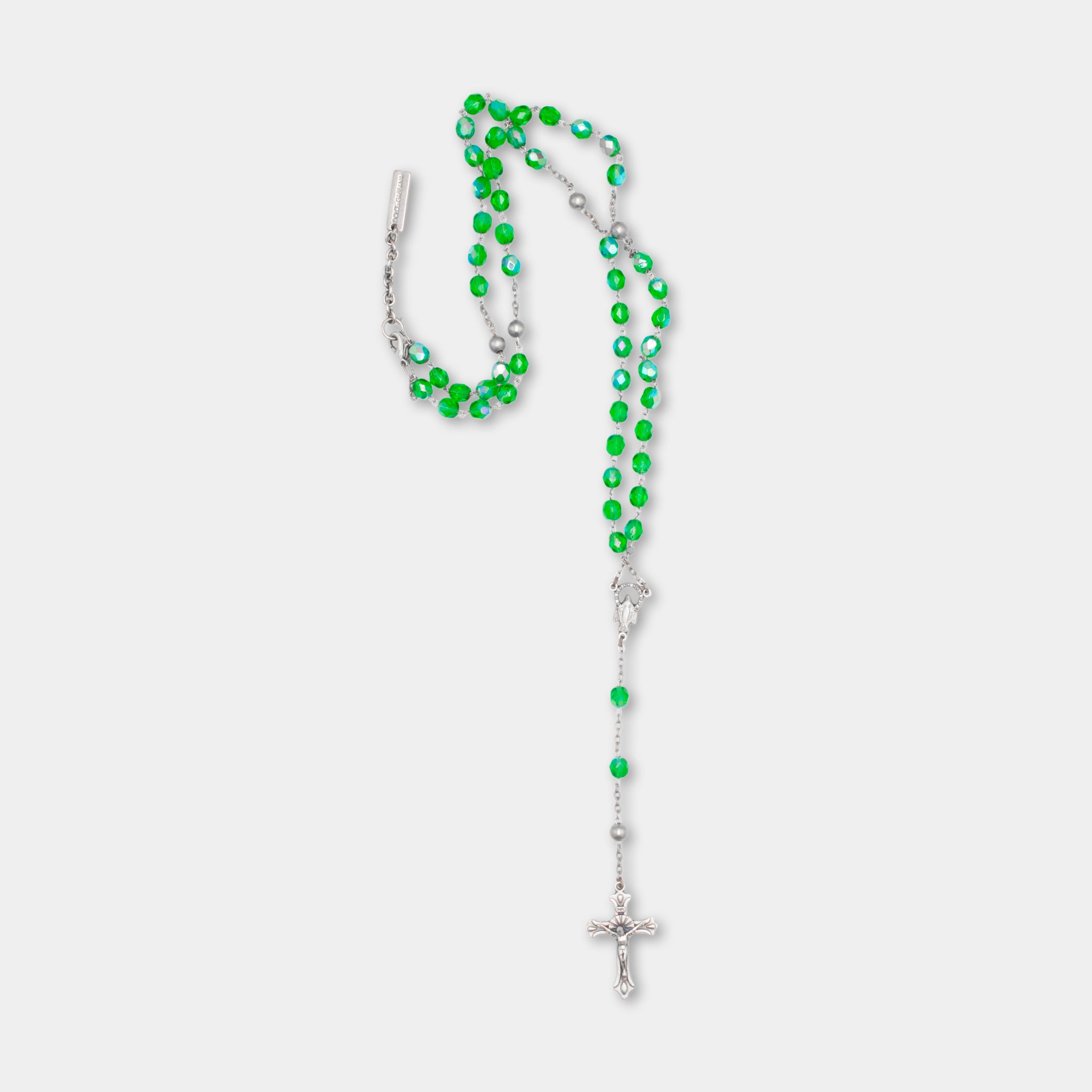 A necklace with green beads and a cross pendant.