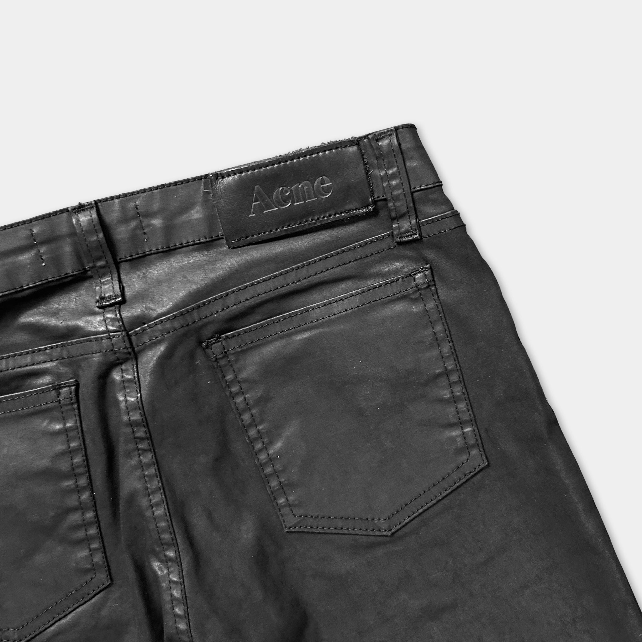 a pair of black leather pants with a label on the back pocket.