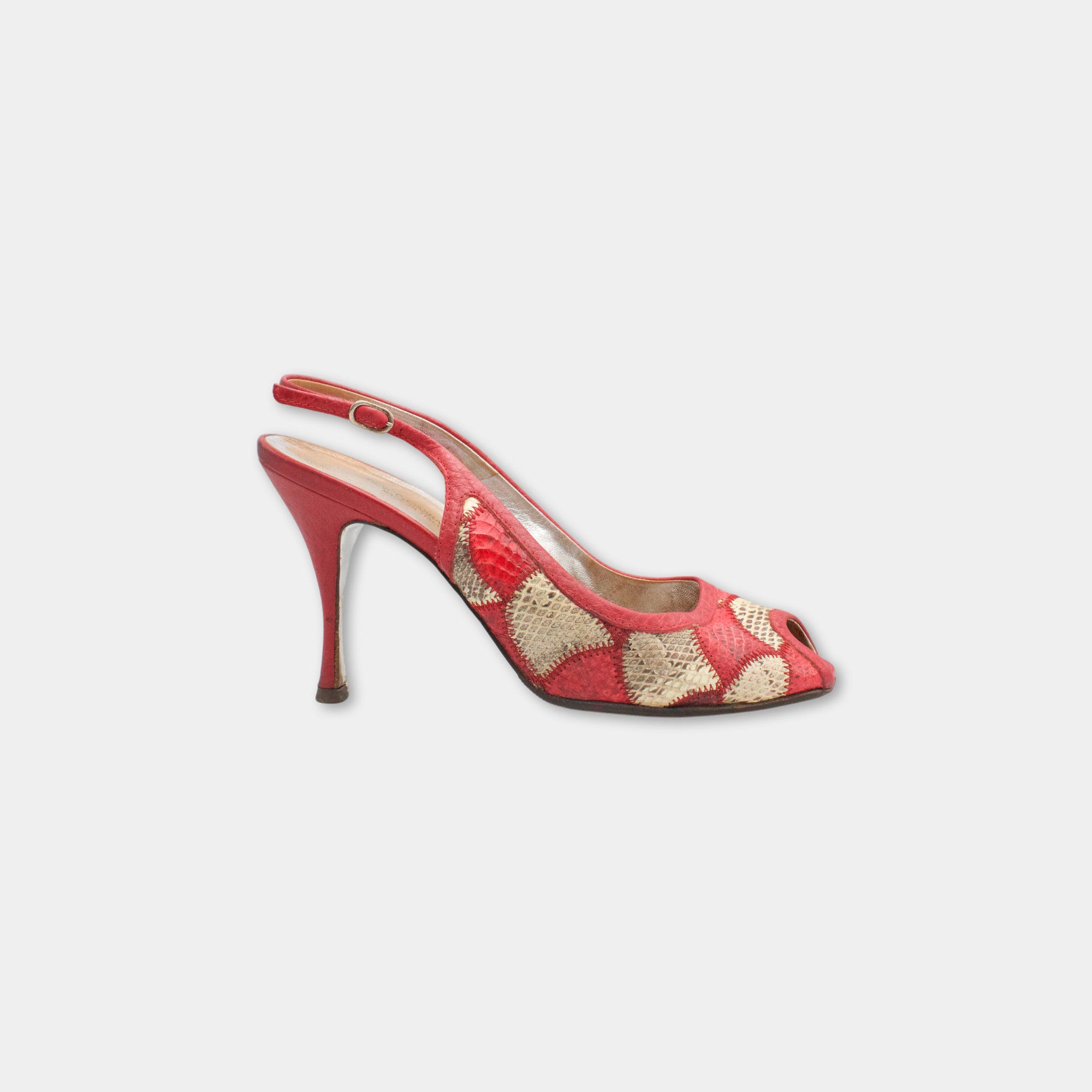 A red high-heeled shoe with a floral pattern on the toe and heel.