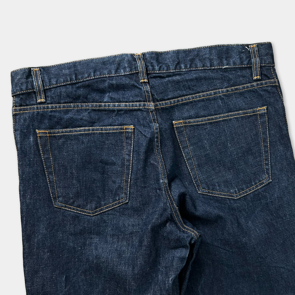 A pair of blue jeans with a zipper and belt.
