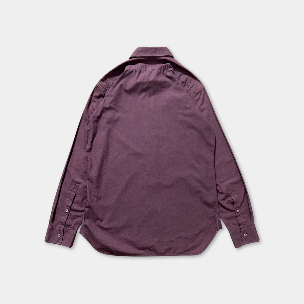 a purple shirt laid out on a white background.