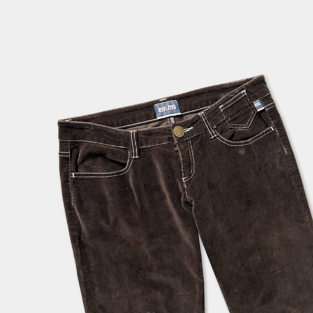 A pair of brown corduroy jeans with a label on the waistband.