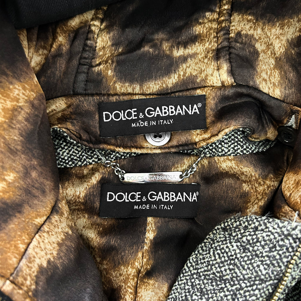 a close-up view of a piece of clothing with two labels attached to it, indicating the brand and the country of manufacture.