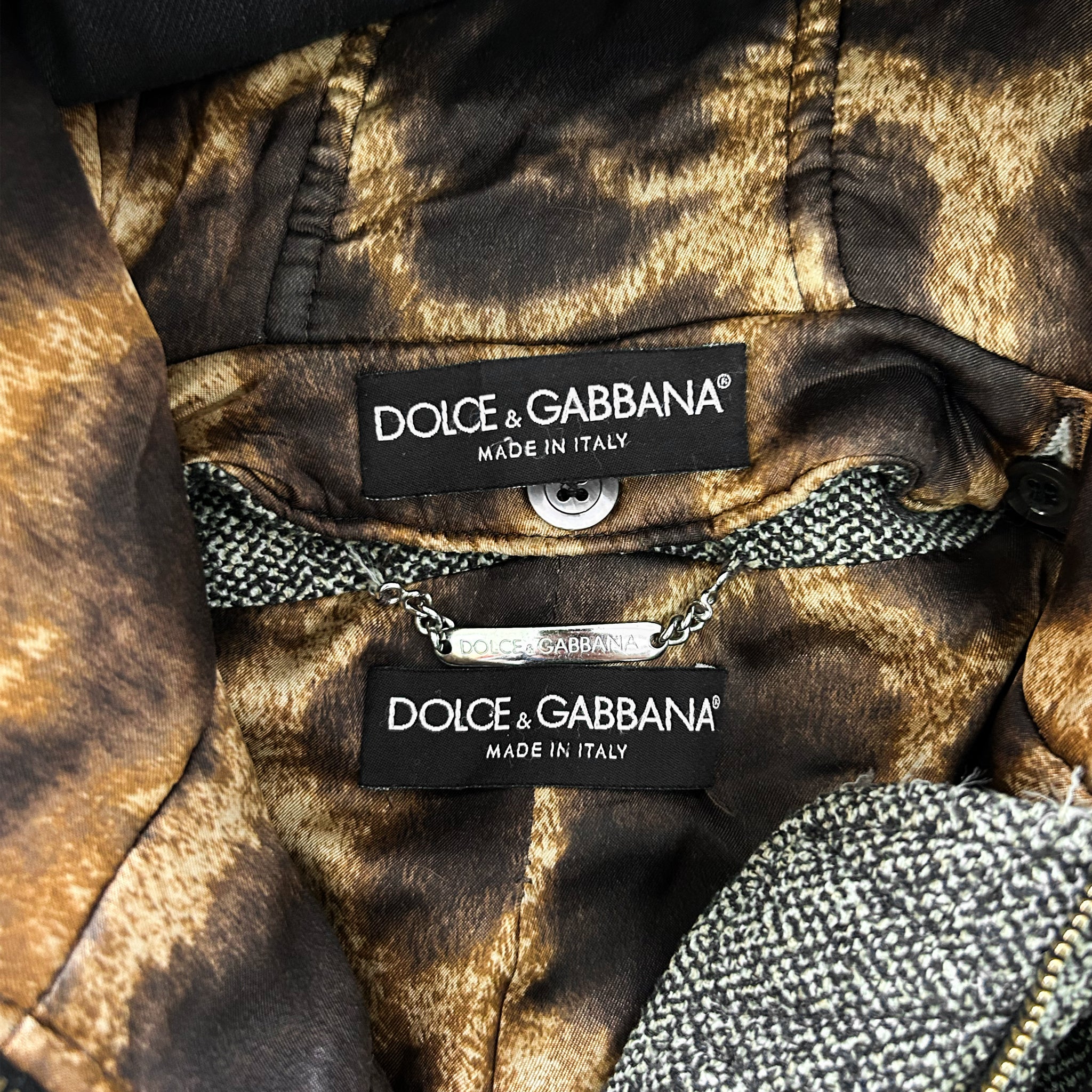 a close-up view of a piece of clothing with two labels attached to it, indicating the brand and the country of manufacture.