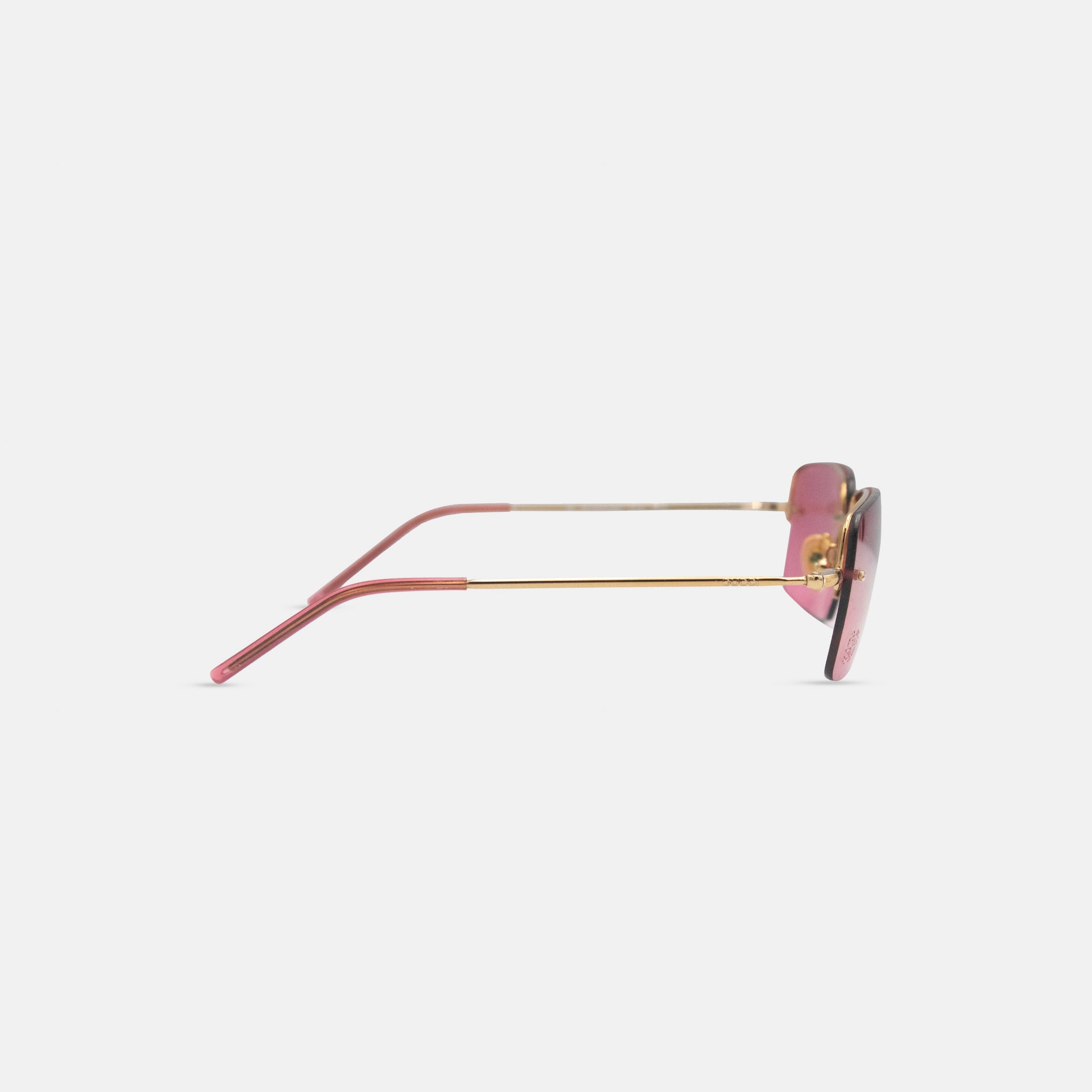 A pair of pink-framed sunglasses with a gold frame is shown against a white background.