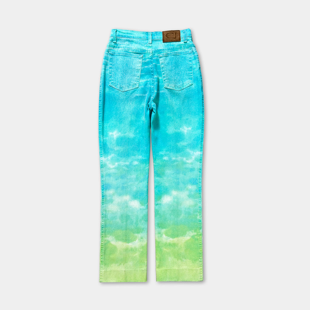 A pair of blue jeans with a tie-dye pattern, featuring a green and blue gradient.
