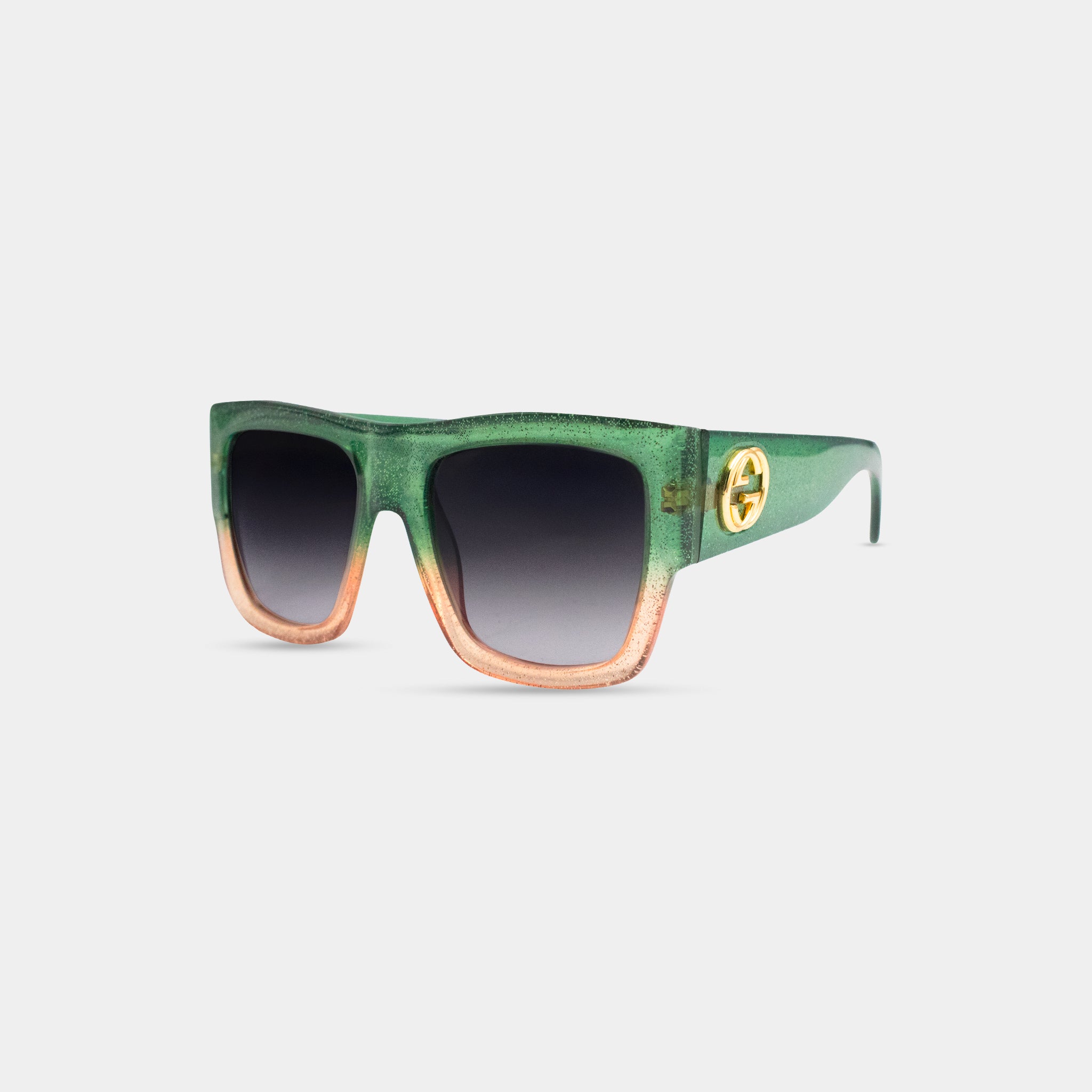 A pair of green and orange sunglasses with a gold Gucci logo on the frame.