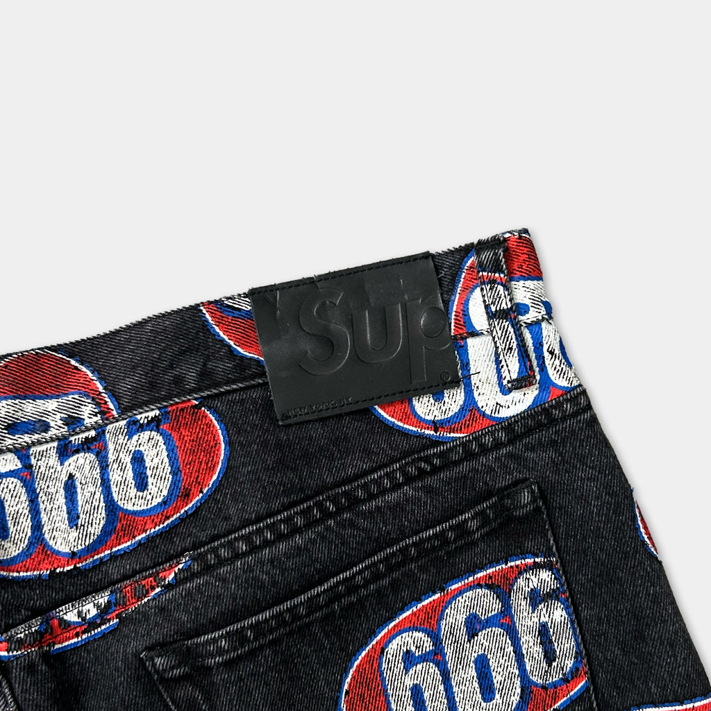a pair of black jeans with a prominent red and blue logo on the back pocket.