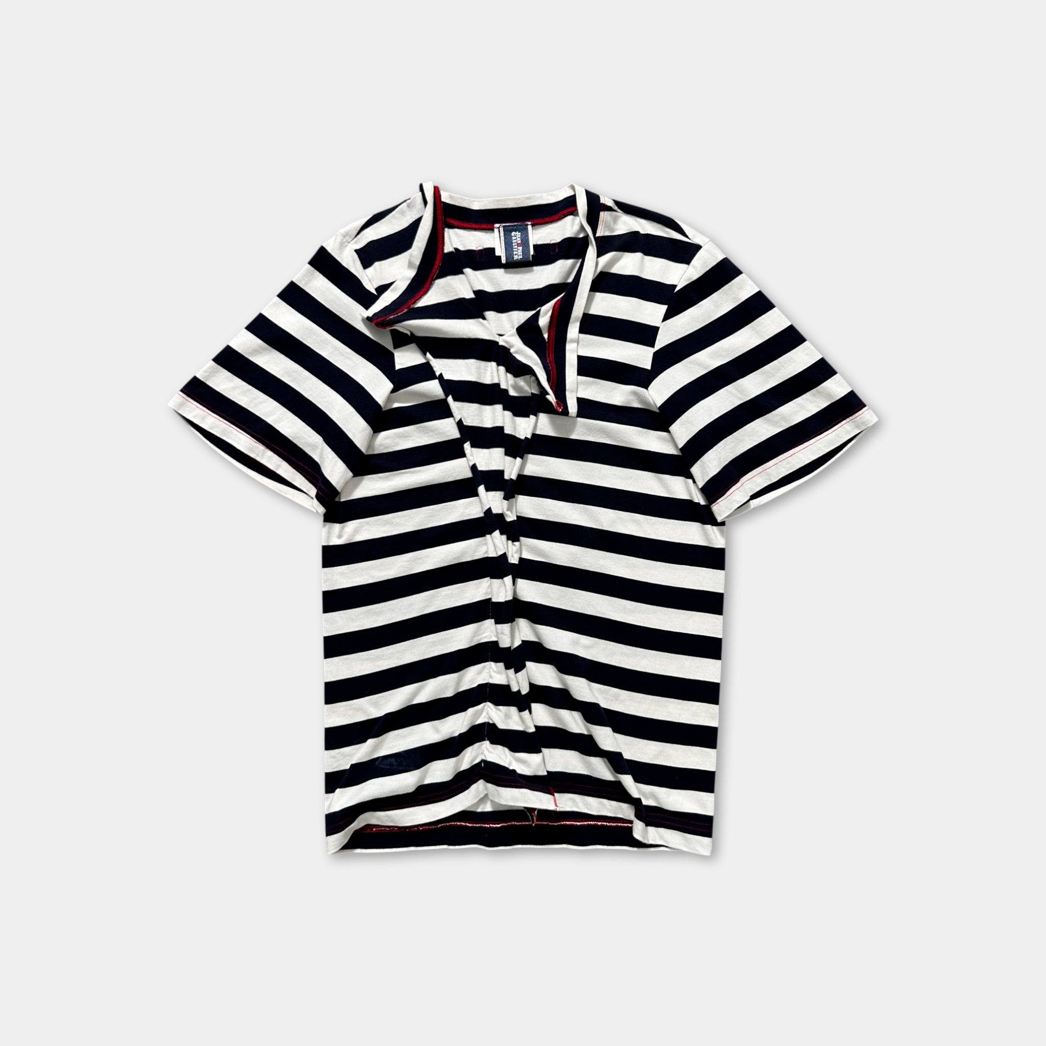 A striped shirt with a red collar and zipper is shown against a plain background.