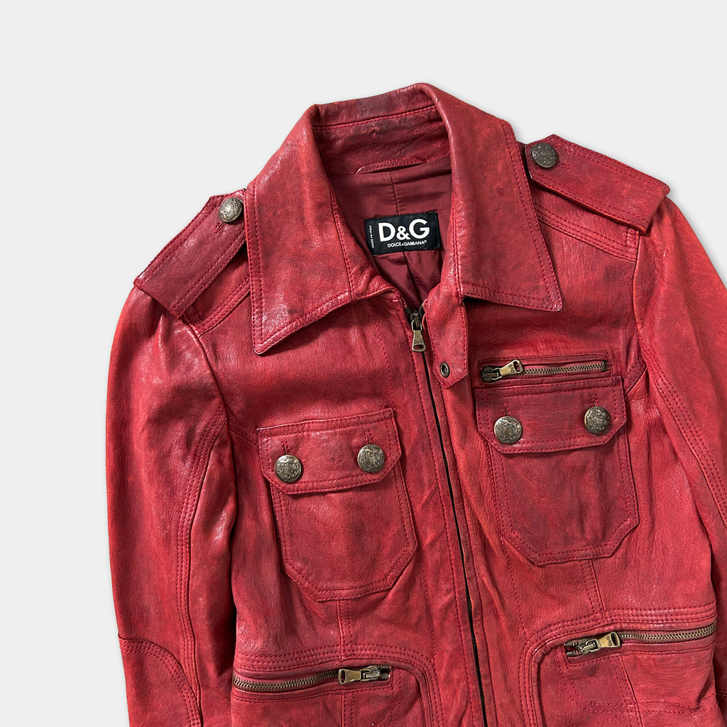 A red leather jacket with multiple pockets and buttons, displayed against a white background.