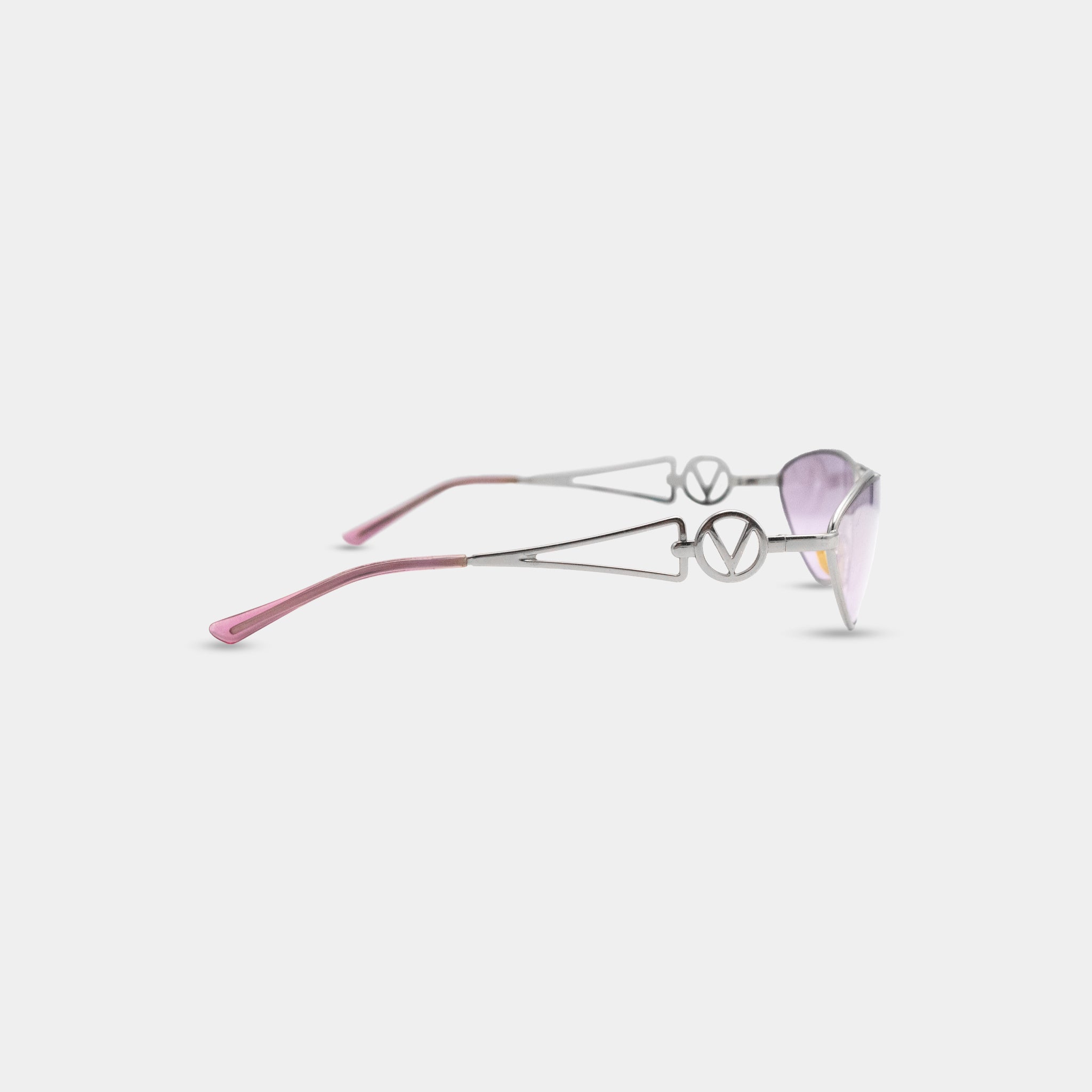 A pair of stylish sunglasses with a silver frame and pink frame, positioned diagonally against a white background.
