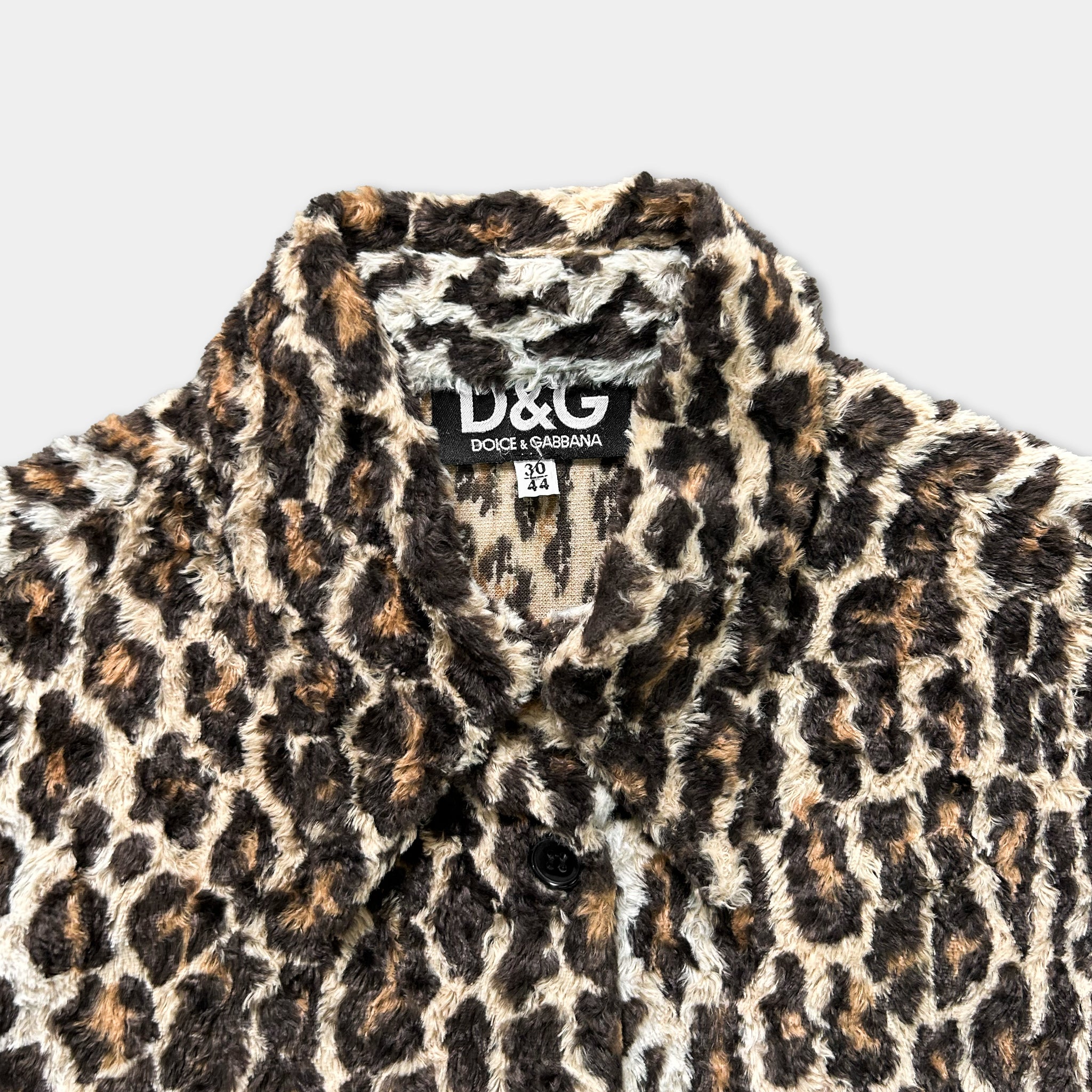 A close-up image of a leopard print jacket with the D&G brand name visible on the collar.