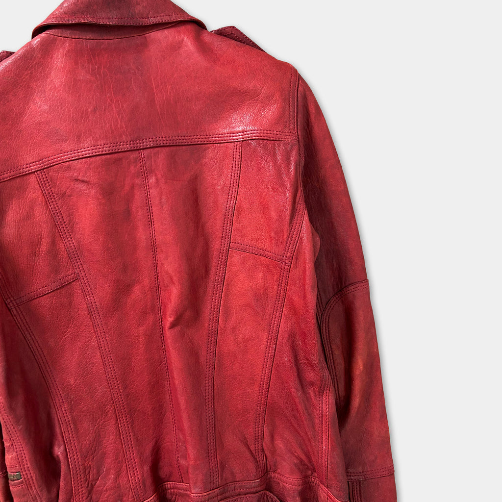 A close-up view of a red leather jacket, showing the back and the details of the jacket's design.