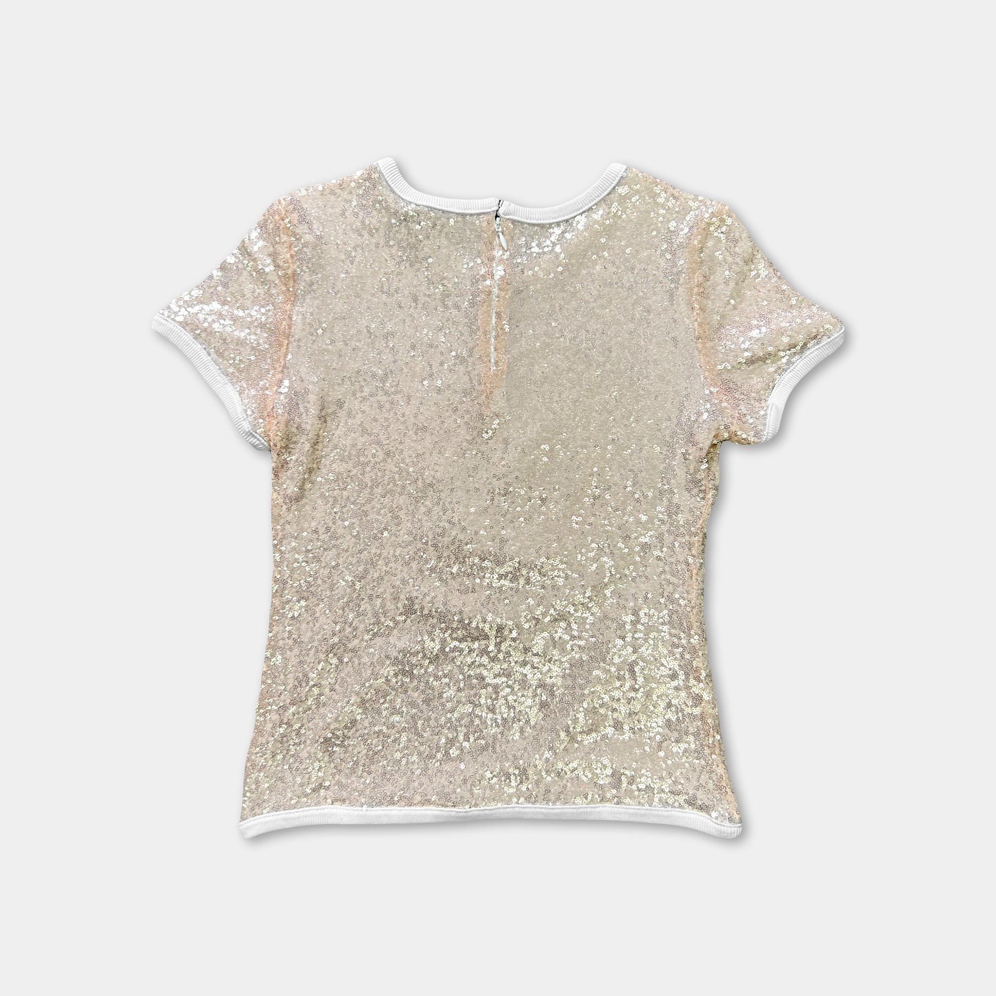 A beige, sparkly top with a white collar and short sleeves is shown against a plain white background.