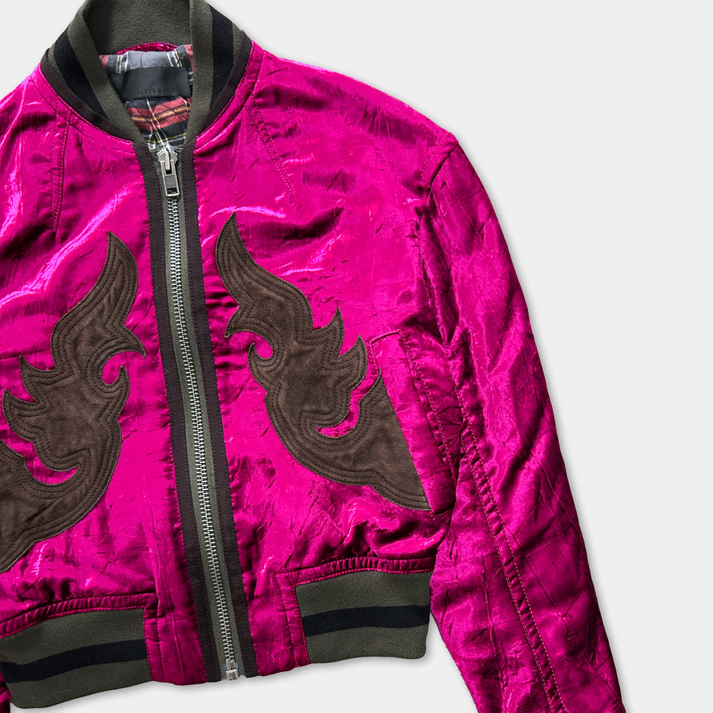 A bright pink satin jacket with a black and brown floral design on the front.