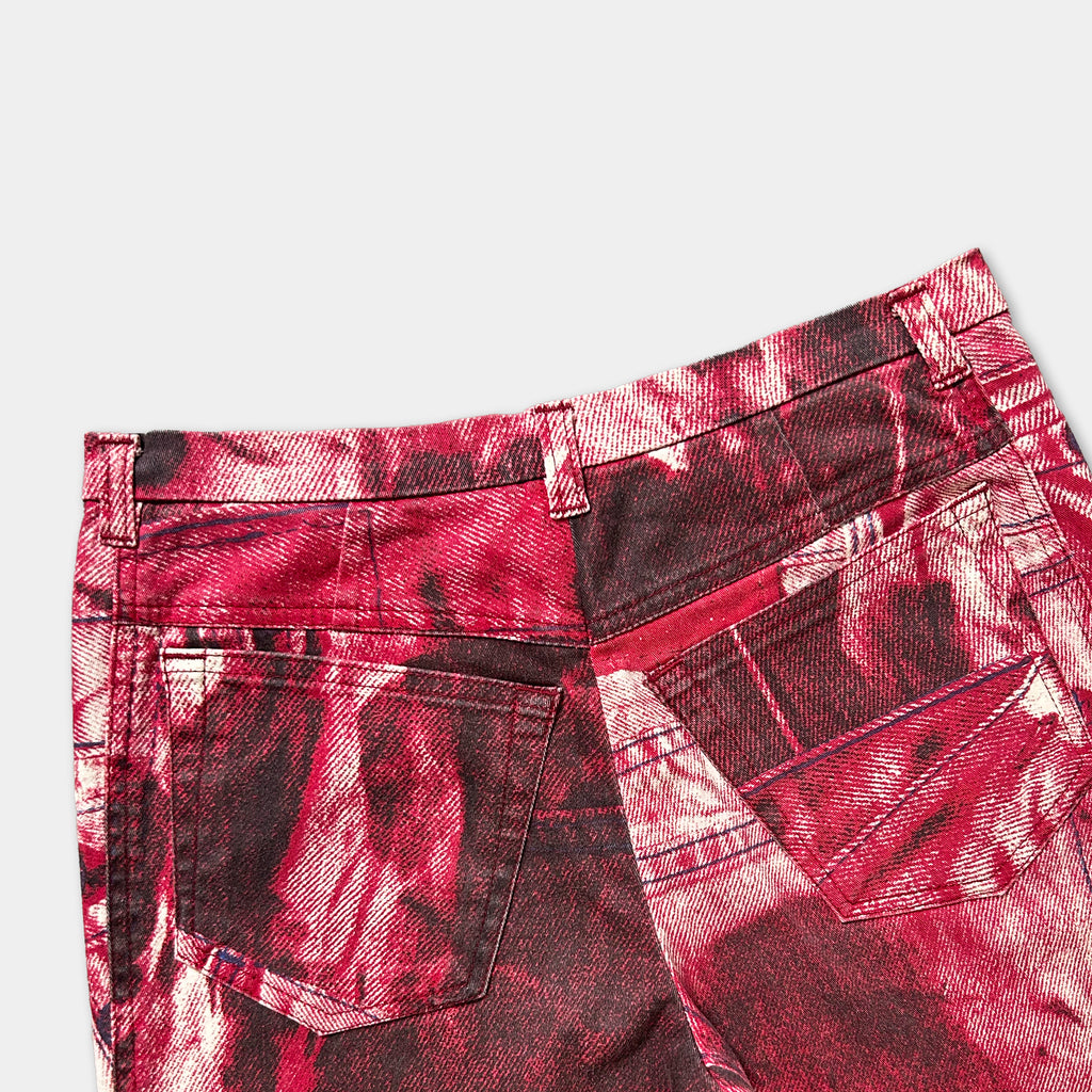 a pair of red and black patterned jeans with a distinctive design.