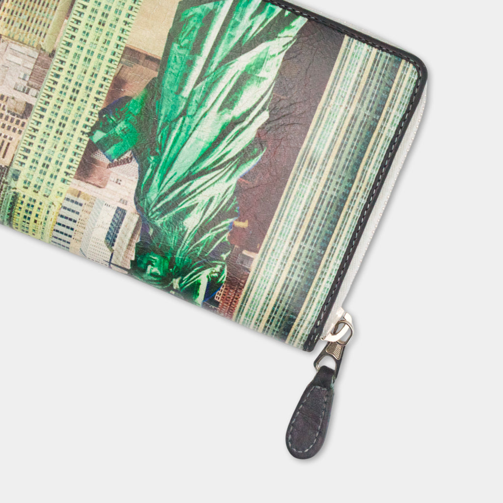A colorful wallet or purse with a printed design of a cityscape, featuring a prominent image of the Statue of Liberty.