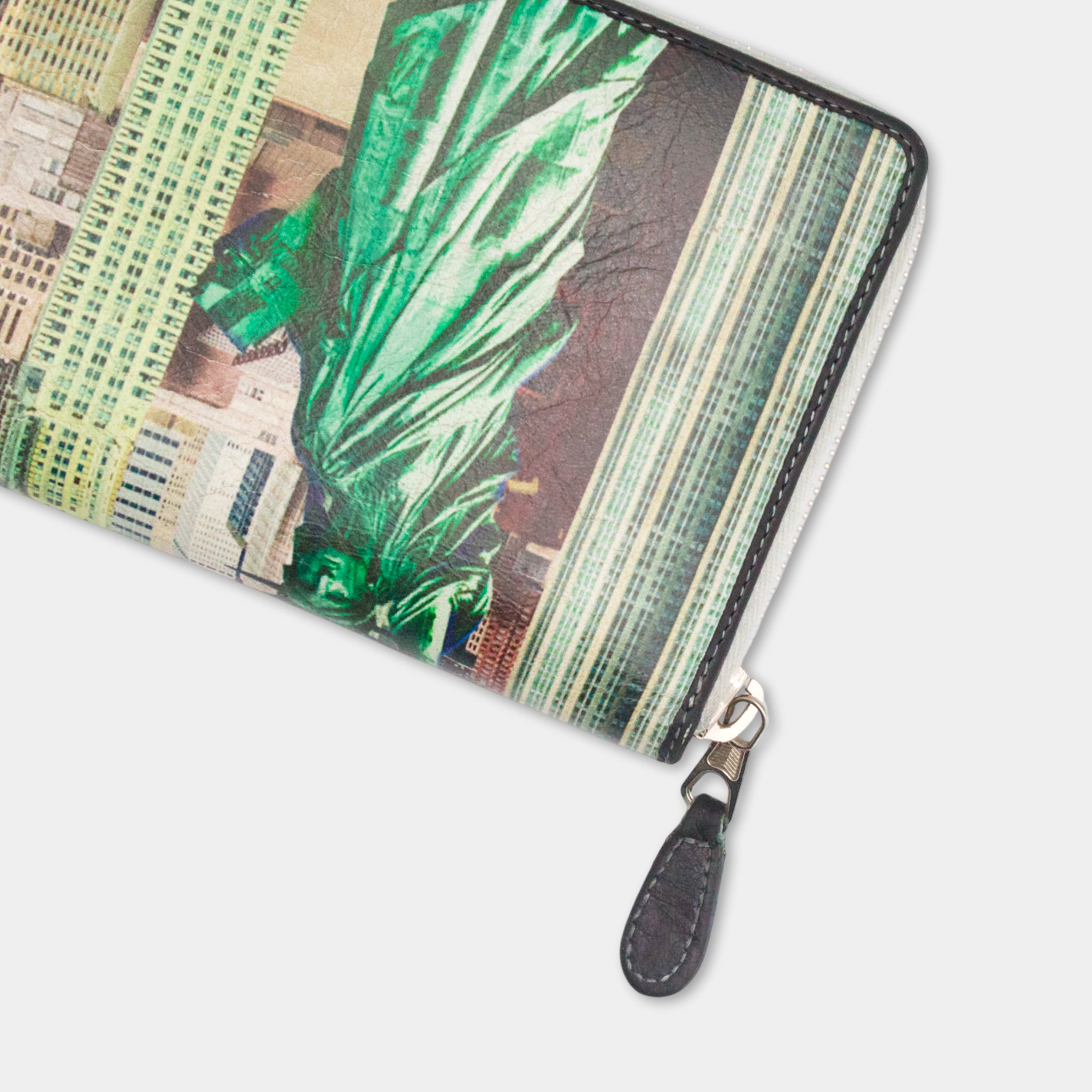 A colorful wallet or purse with a printed design of a cityscape, featuring a prominent image of the Statue of Liberty.
