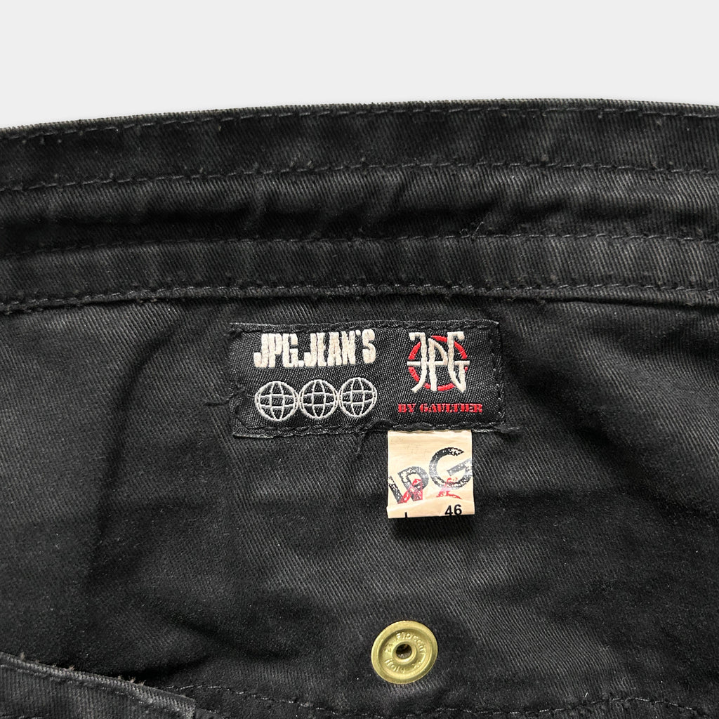 a close-up view of a black fabric, possibly a piece of clothing, with a label or tag attached to it.