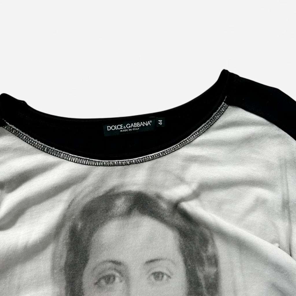 a close-up view of a black and white t-shirt with a printed image of a woman's face on it.