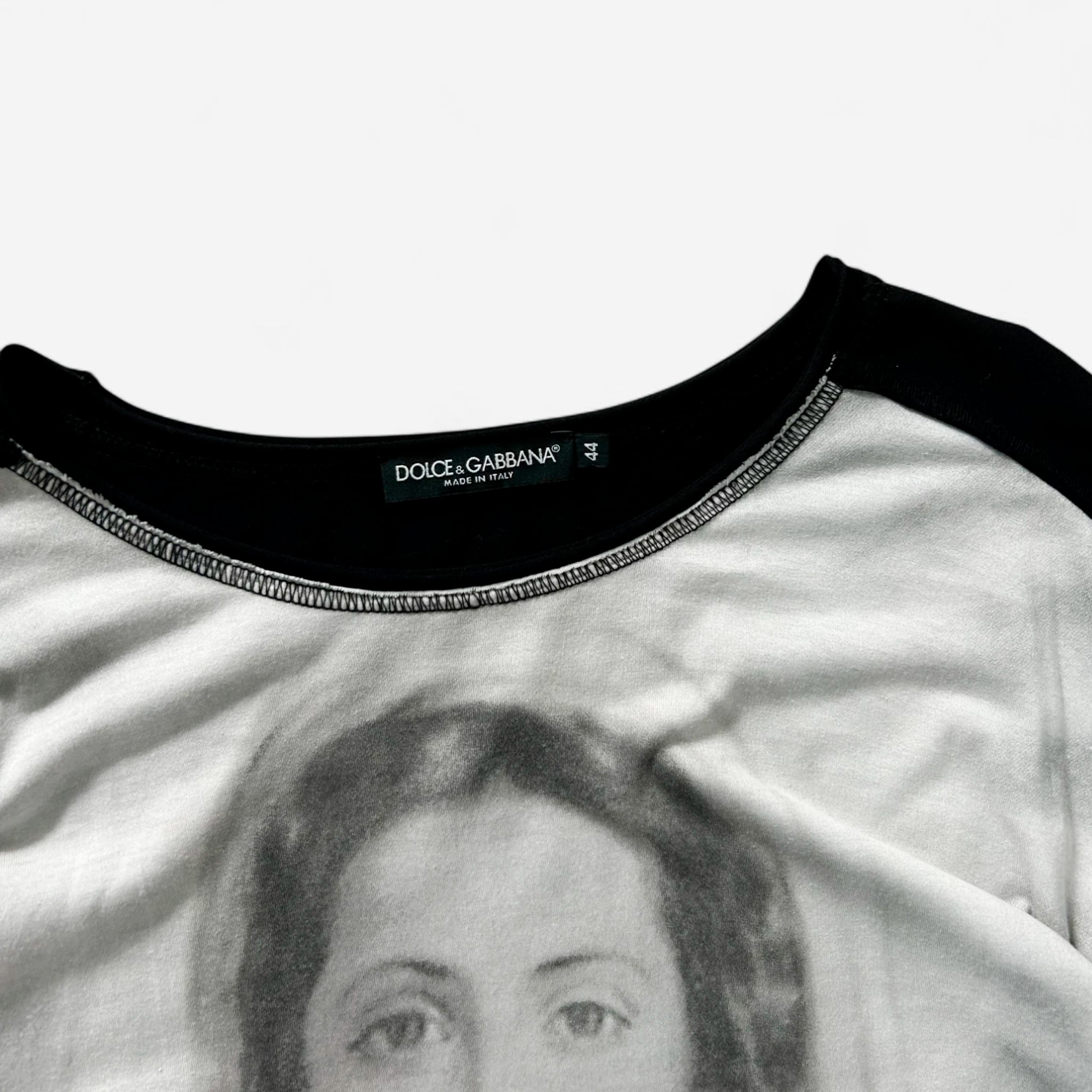 a close-up view of a black and white t-shirt with a printed image of a woman's face on it.