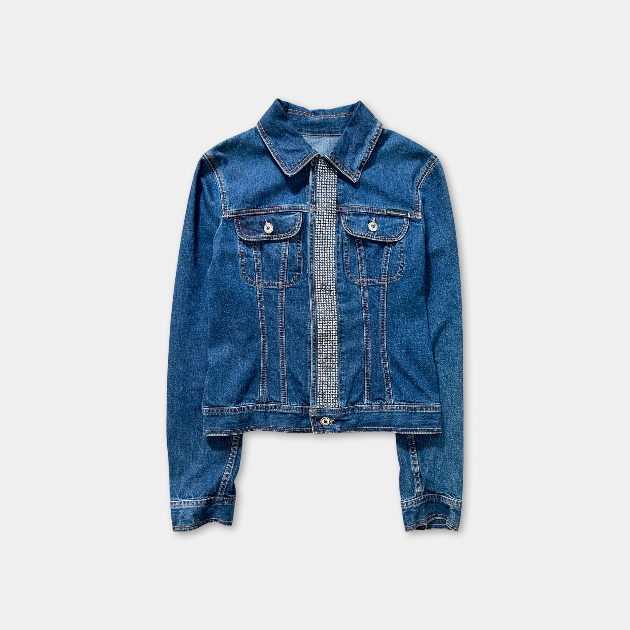 A denim jacket with a zipper and pockets, featuring a diamond-patterned trim on the front.