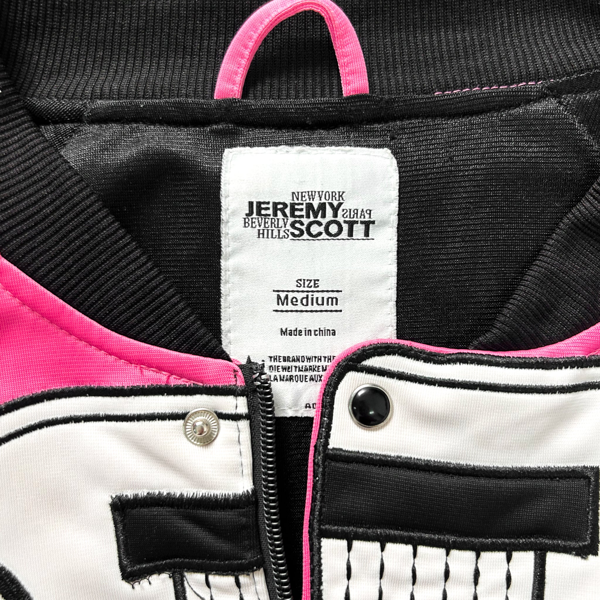 a close-up view of a jacket label, featuring the brand name and size information.