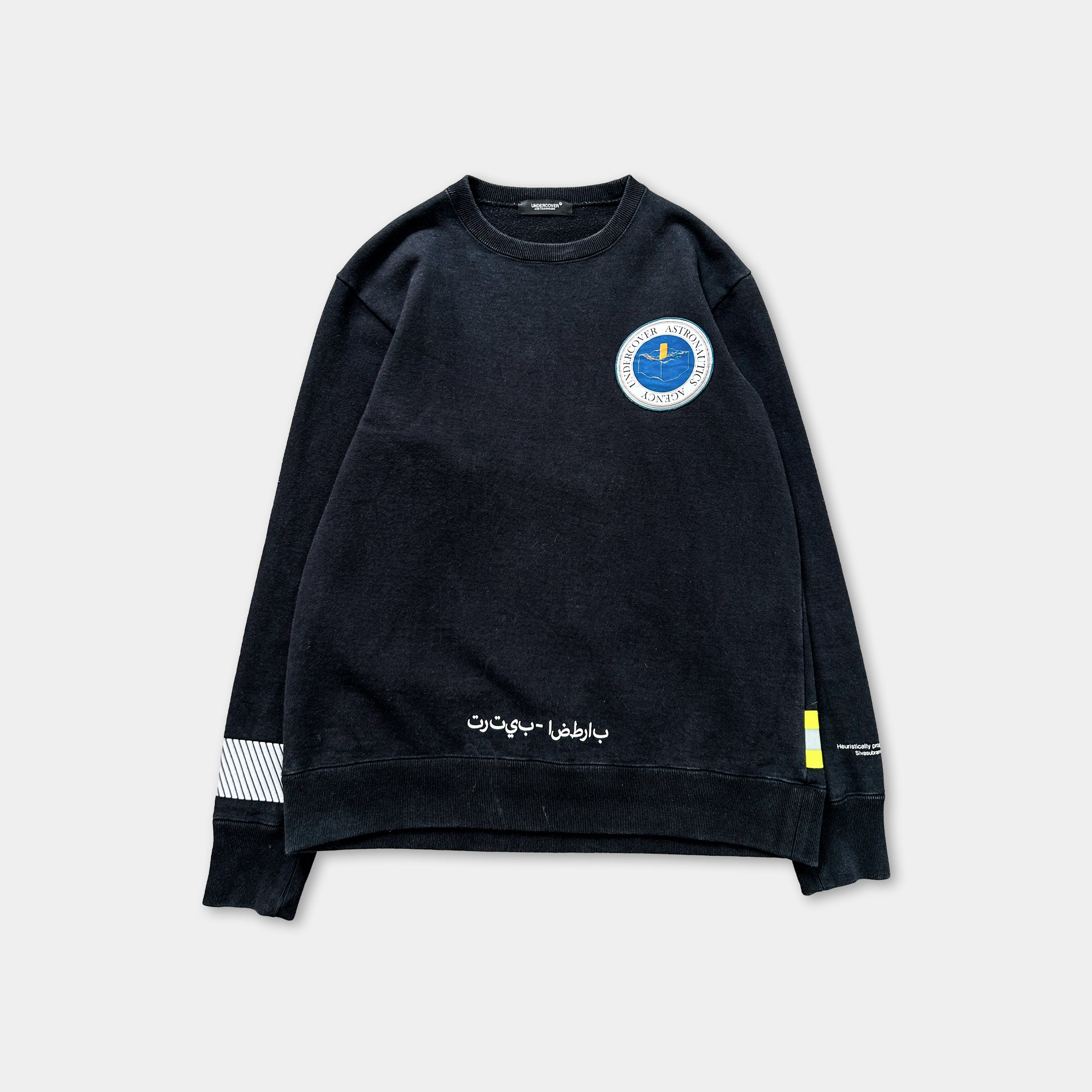 A black sweatshirt with a blue and white circular logo on the left chest area.