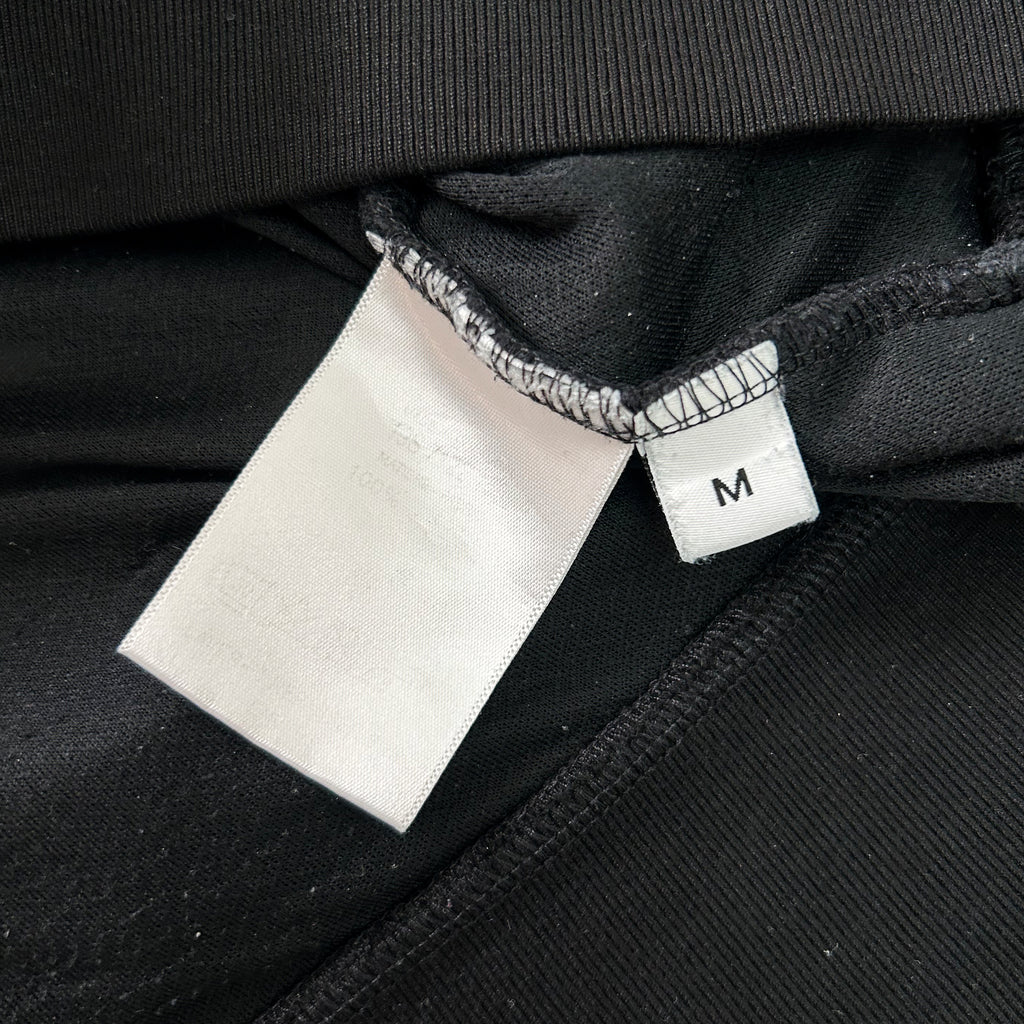 a close-up view of a black fabric with a white label attached to it.