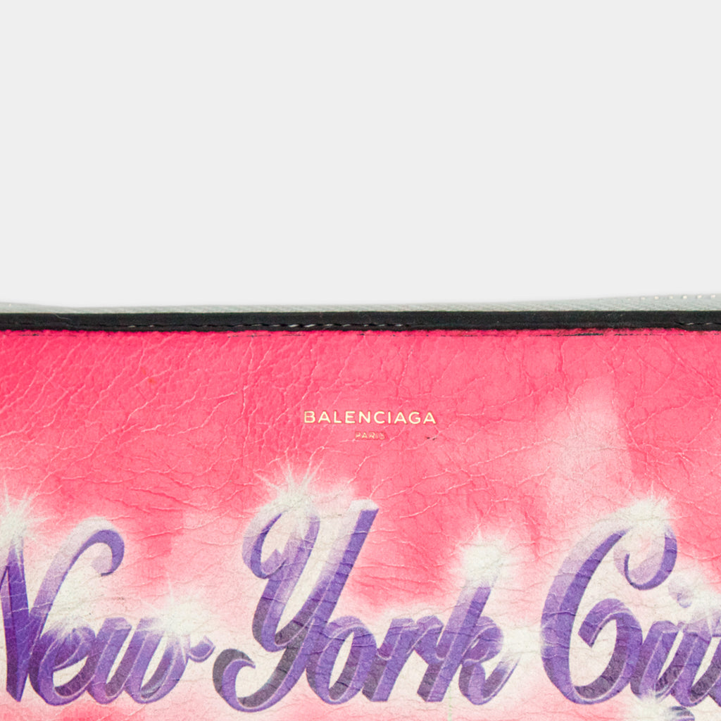 A close-up of a pink and purple textured surface with the word "New York City" written in a stylized font.