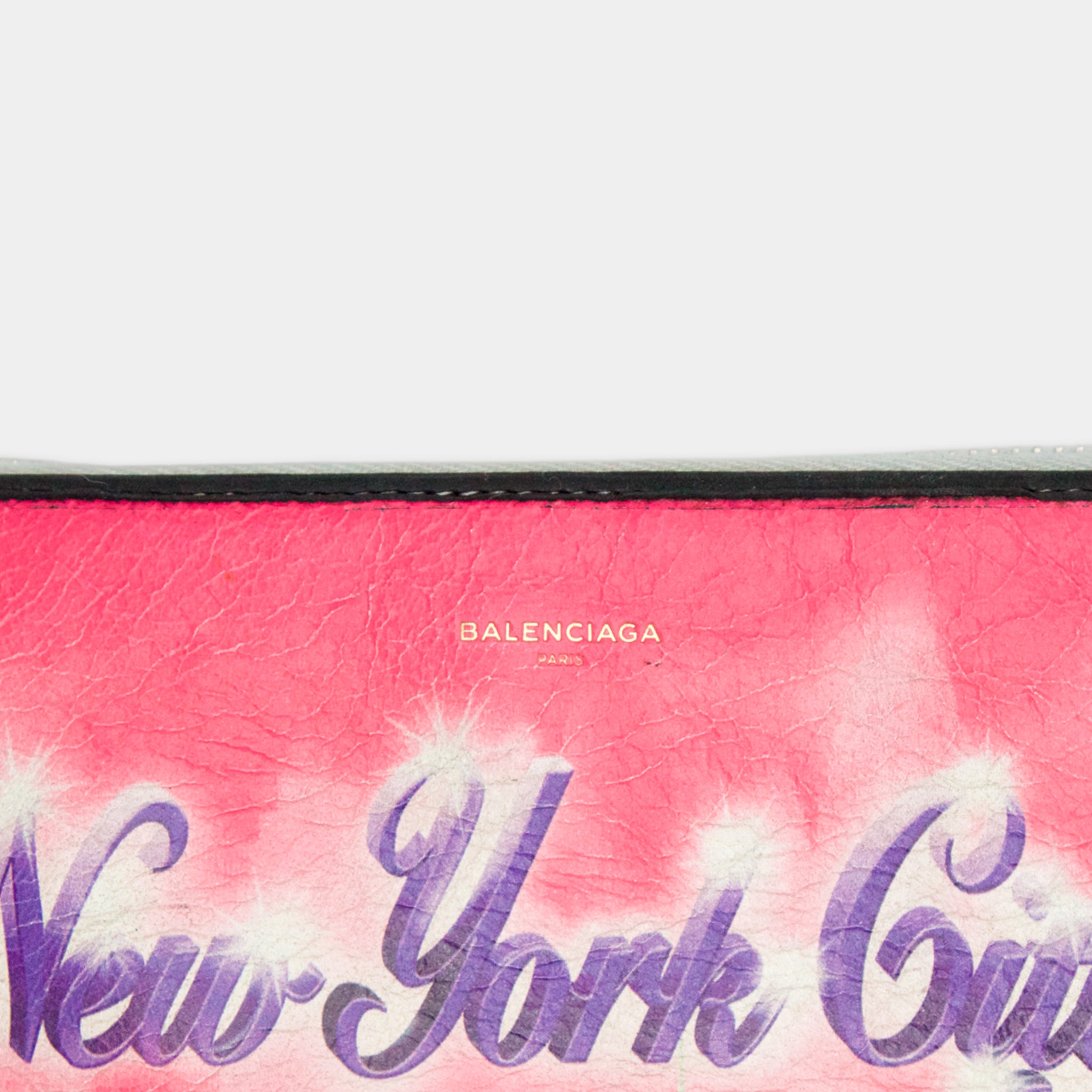 A close-up of a pink and purple textured surface with the word "New York City" written in a stylized font.