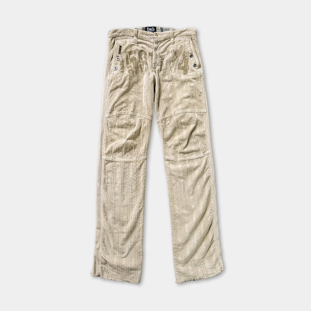A pair of beige corduroy pants with a zipper and pockets.