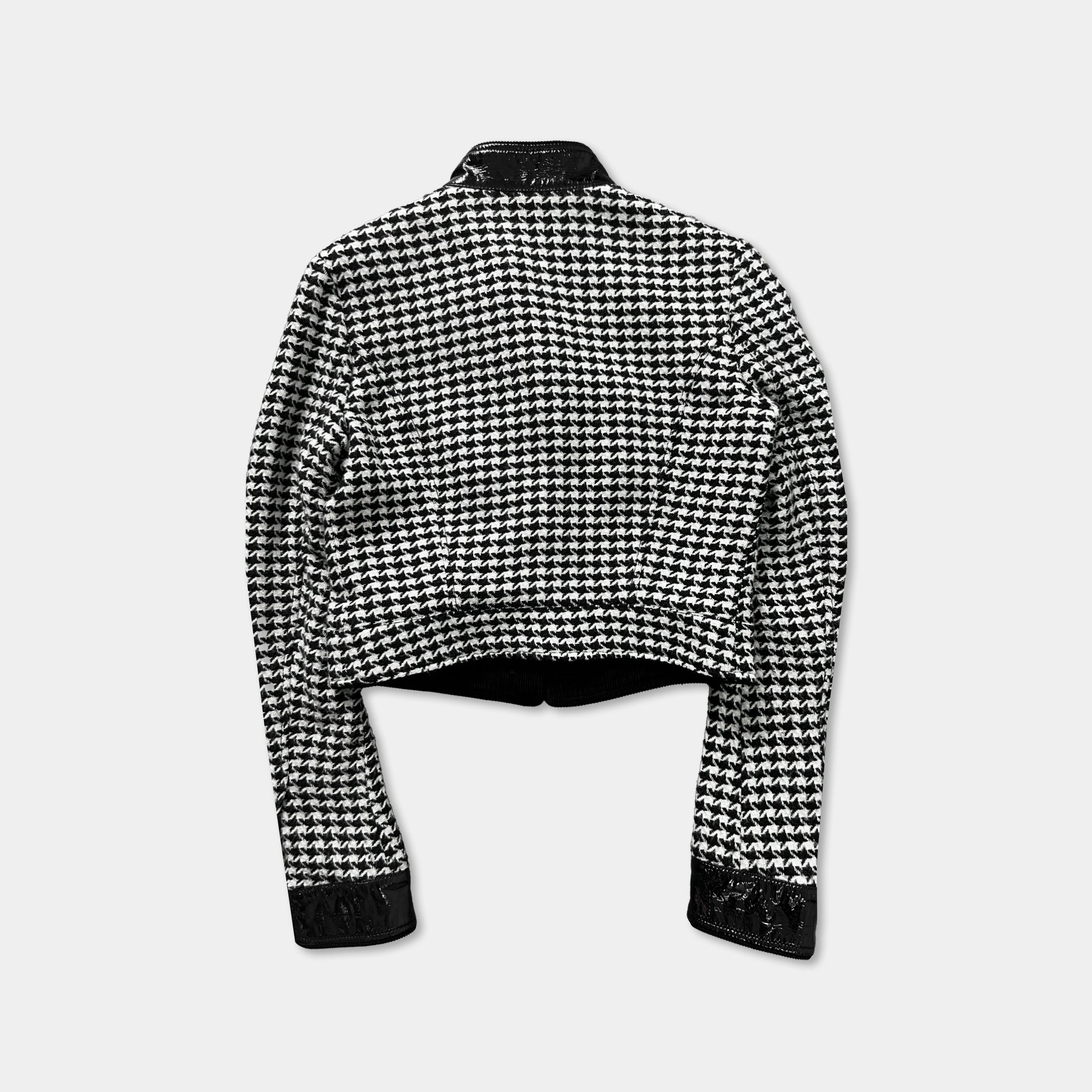 A black and white checkered jacket with a collar and long sleeves, displayed against a plain background.