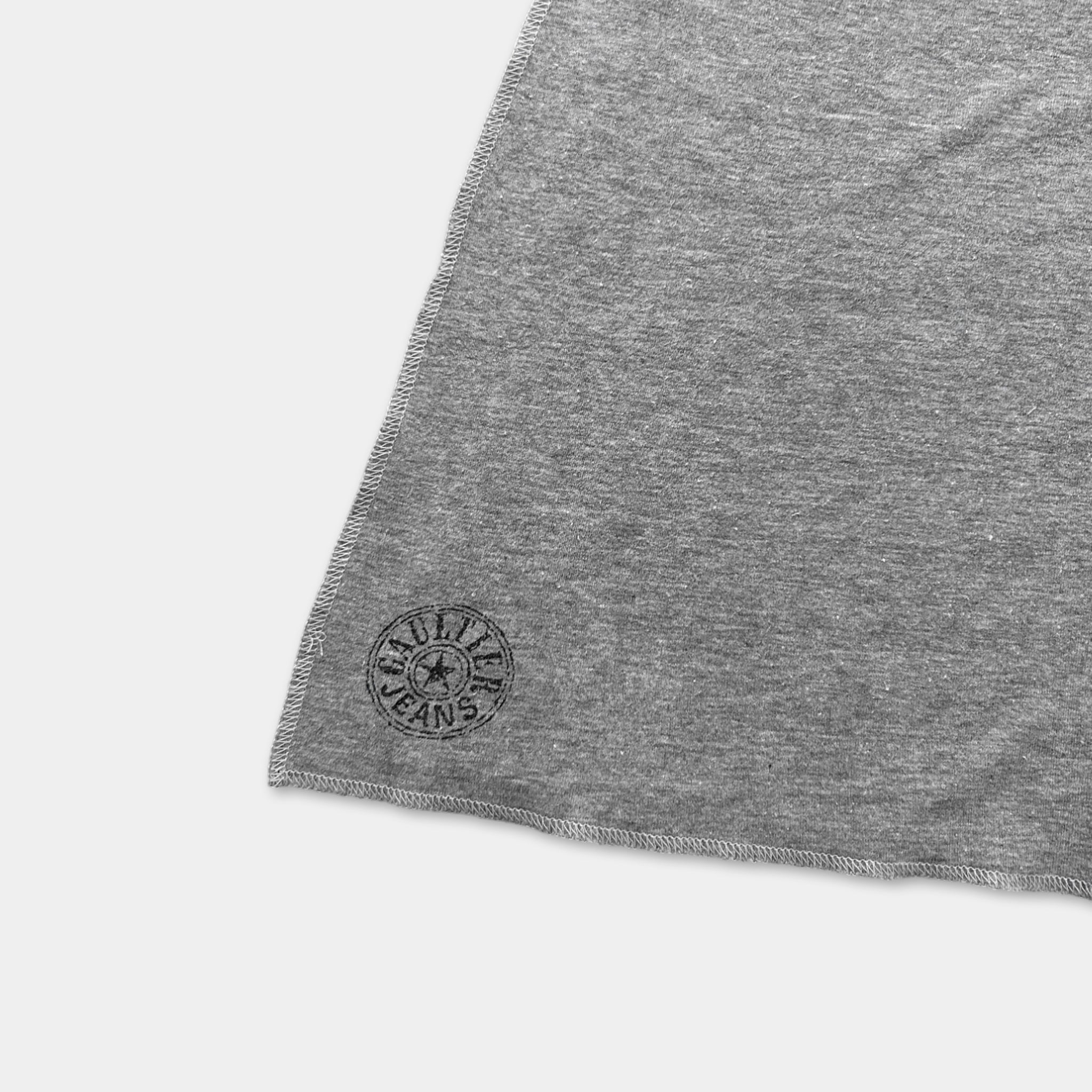 A gray fabric with a circular logo on it.