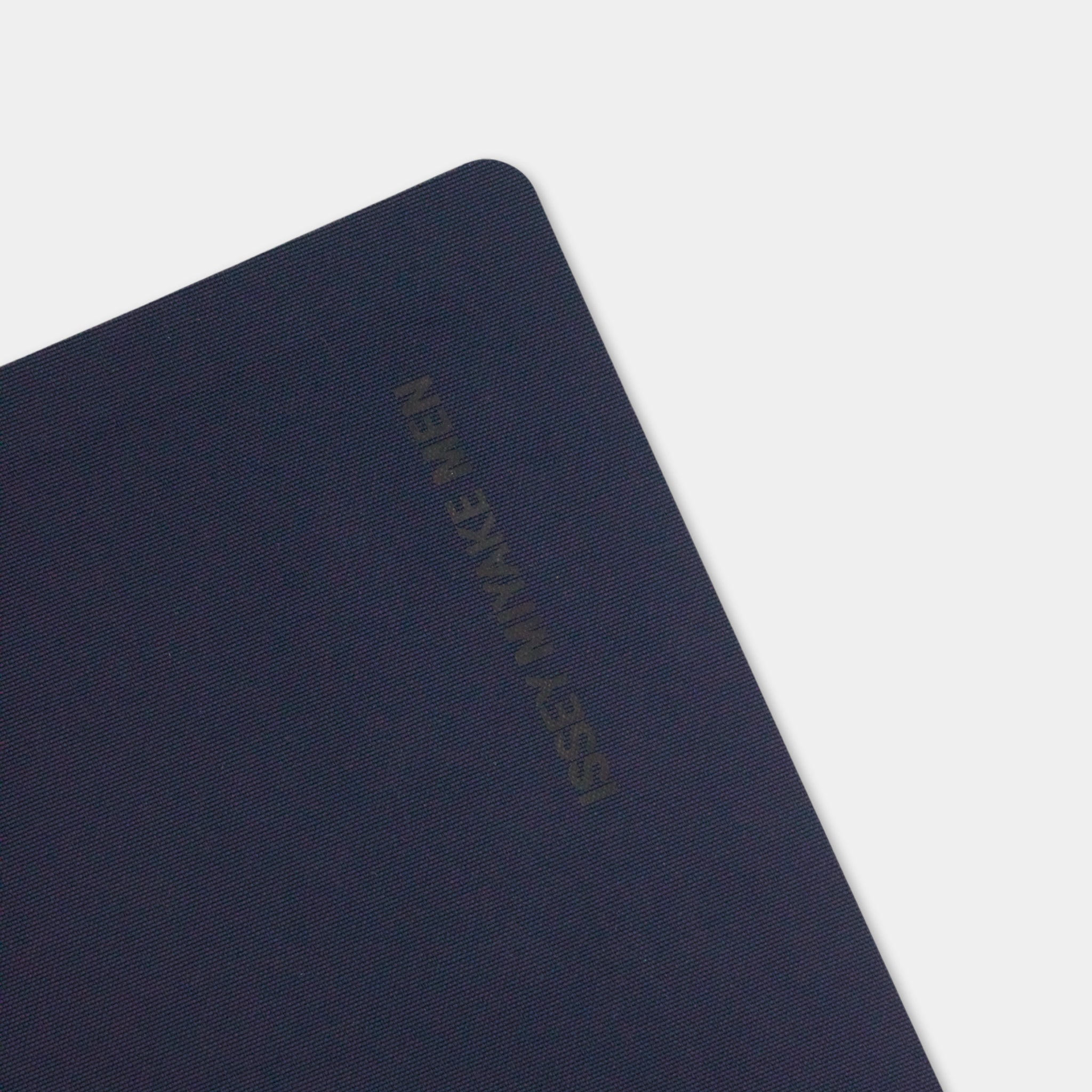 A dark blue notebook with the text "ISSUE NOKKE MEN" printed on it.