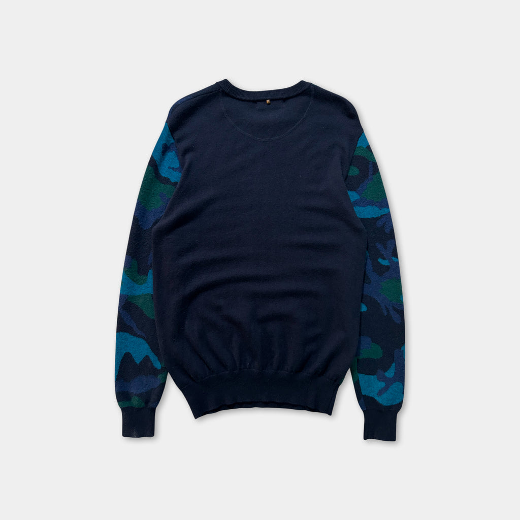 A navy blue long-sleeved sweater with camouflage patterns on the sleeves.