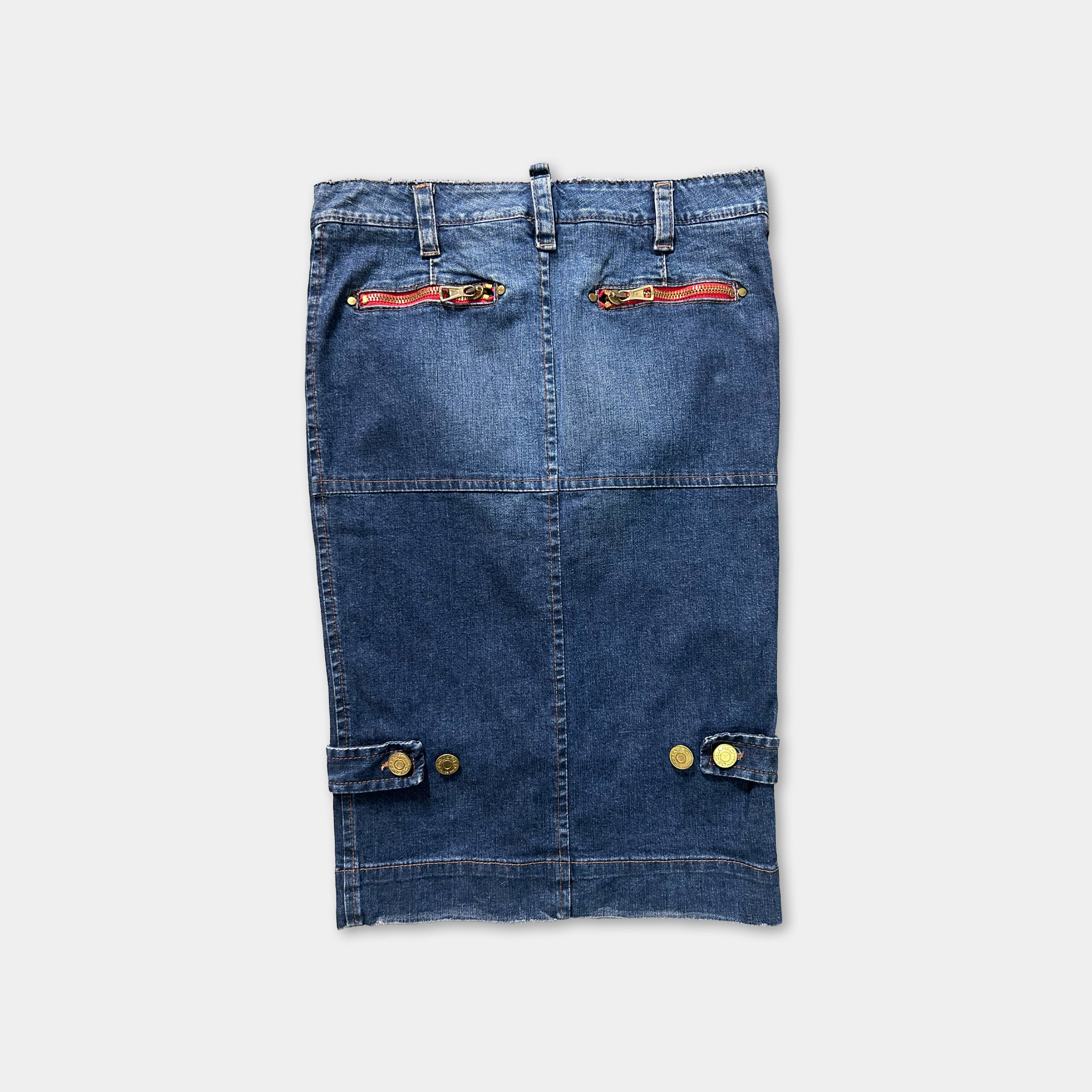 A pair of blue jeans with red zipper pulls and gold buttons on the front pockets.