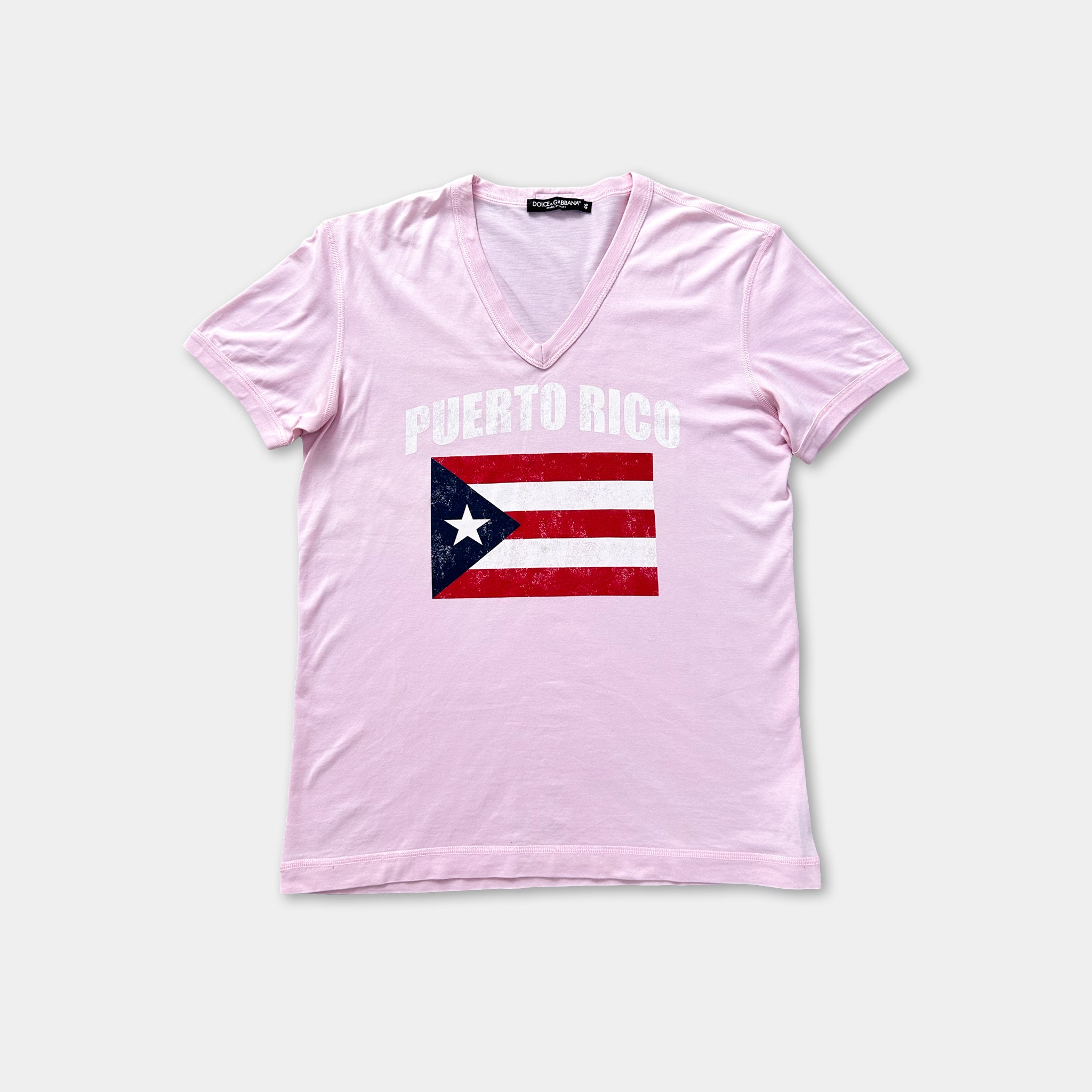 A pink t-shirt with the text "PUERTO RICO" printed on it, along with an American flag graphic.