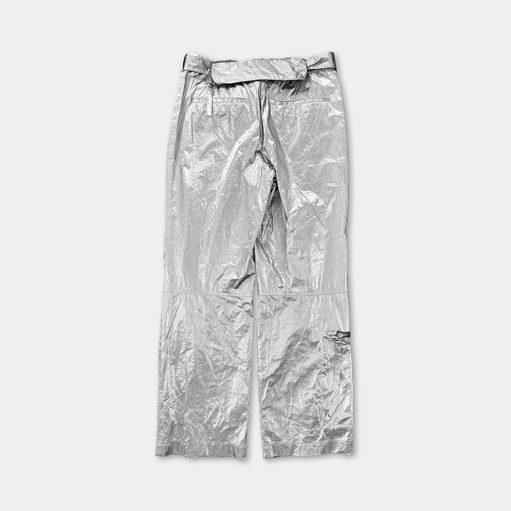 A pair of shiny silver pants against a white background.