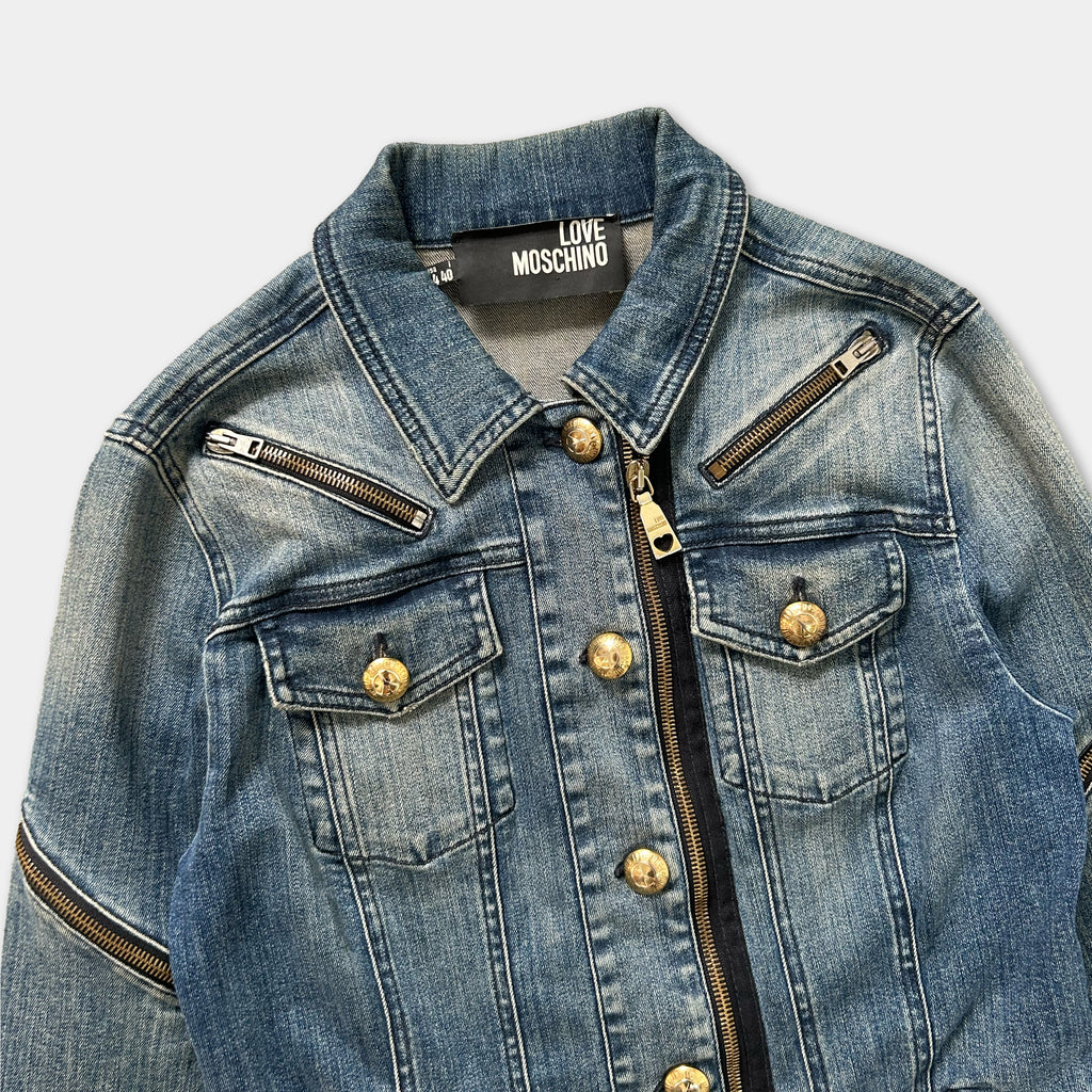 A denim jacket with a zipper and buttons, featuring the Love Moschino brand name on the collar.