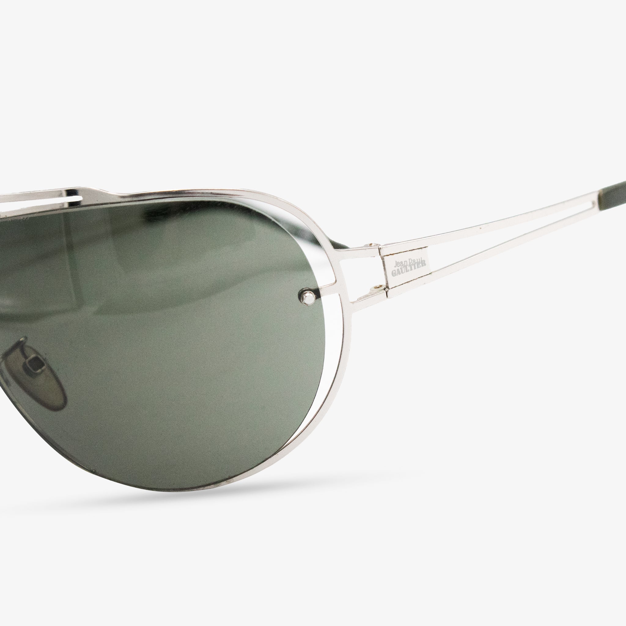 A pair of silver-framed sunglasses with dark lenses.
