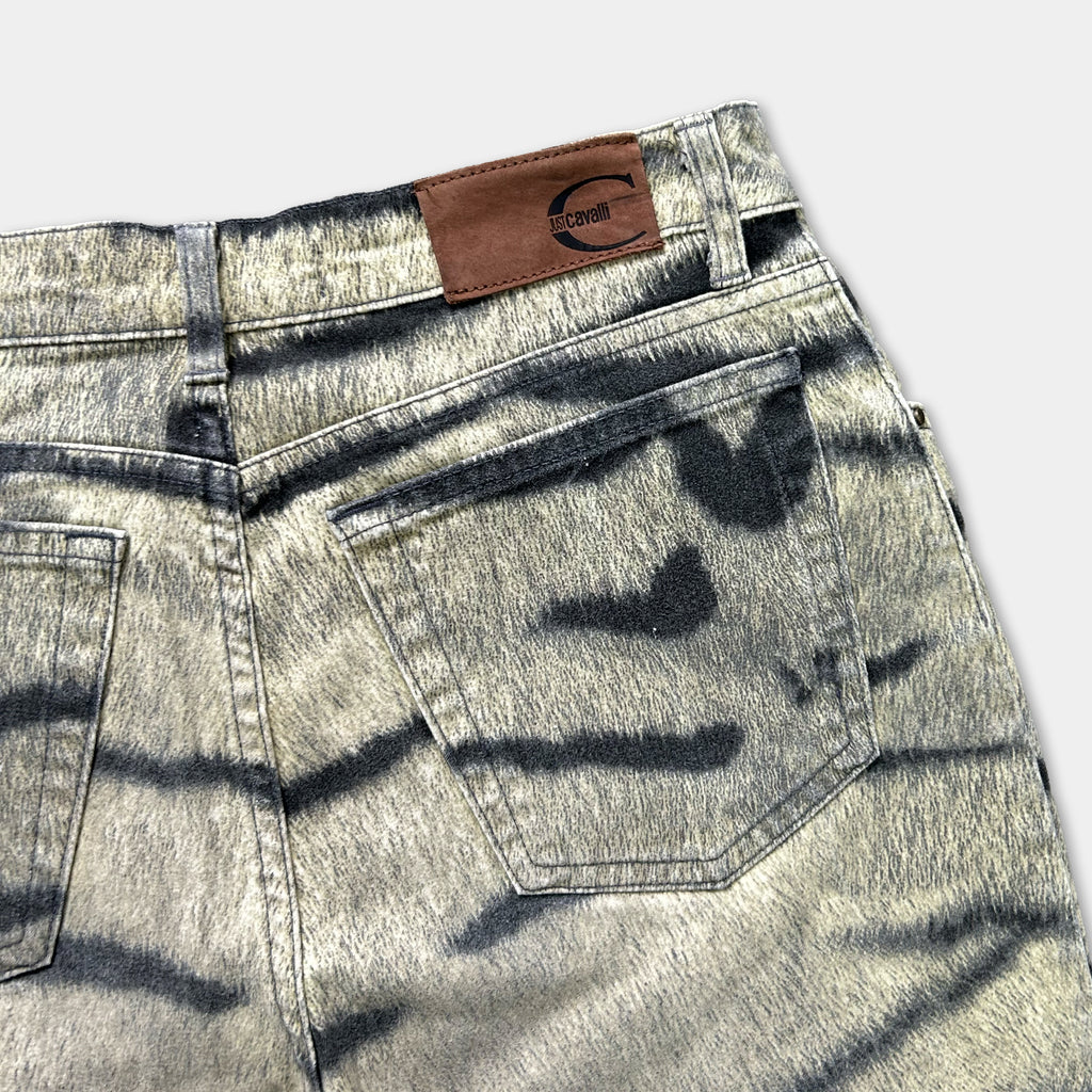 A pair of gray and black striped jeans with a brown leather patch on the waistband.