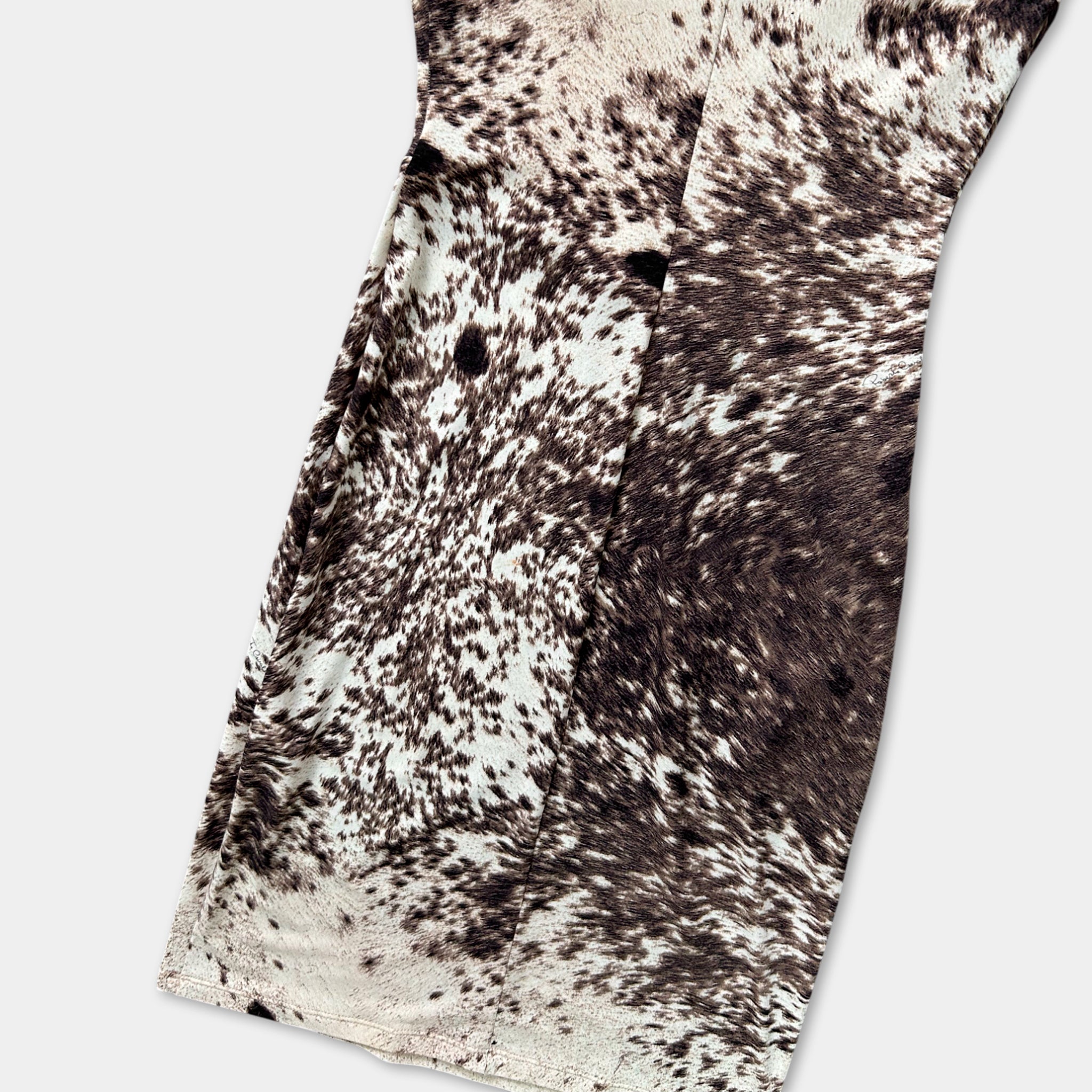 a close-up view of a dress with a unique, spotted pattern in shades of brown and white.