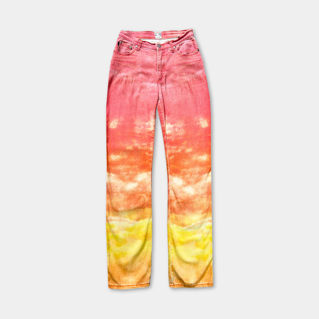 A pair of colorful, tie-dye jeans with a gradient pattern of pink, orange, and yellow.