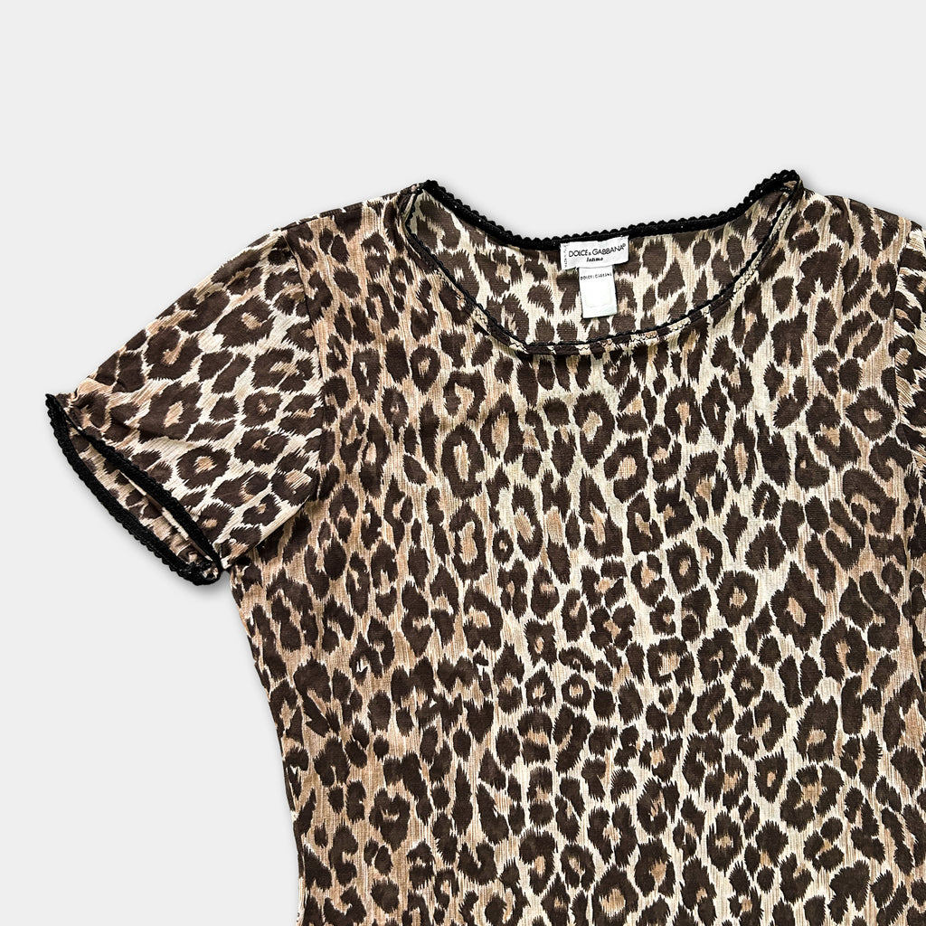 A leopard print dress with a black collar and trim.