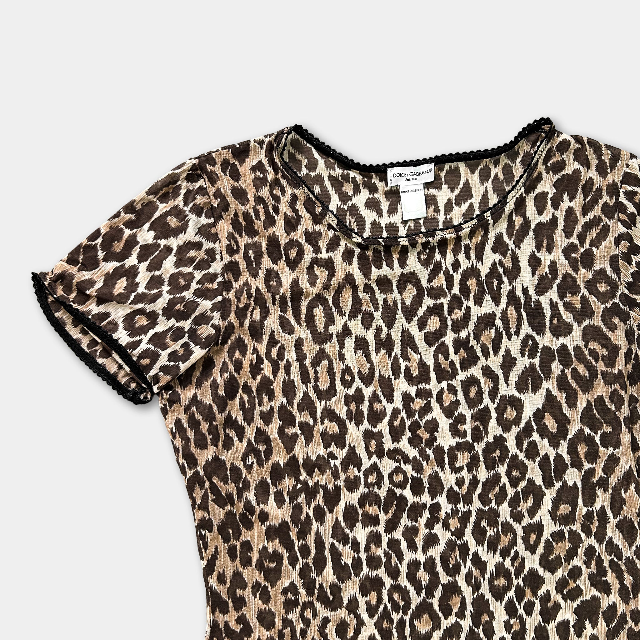 A leopard print dress with a black collar and trim.