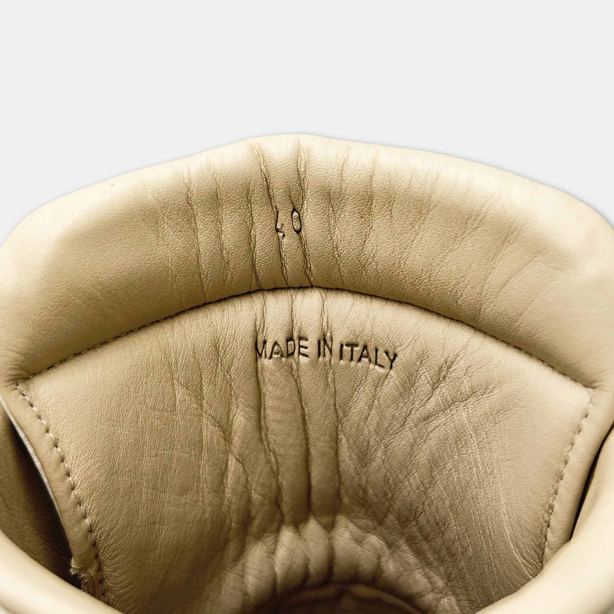 the interior of a shoe, specifically the sole and the heel, with the text "MADE IN ITALY" printed on it.